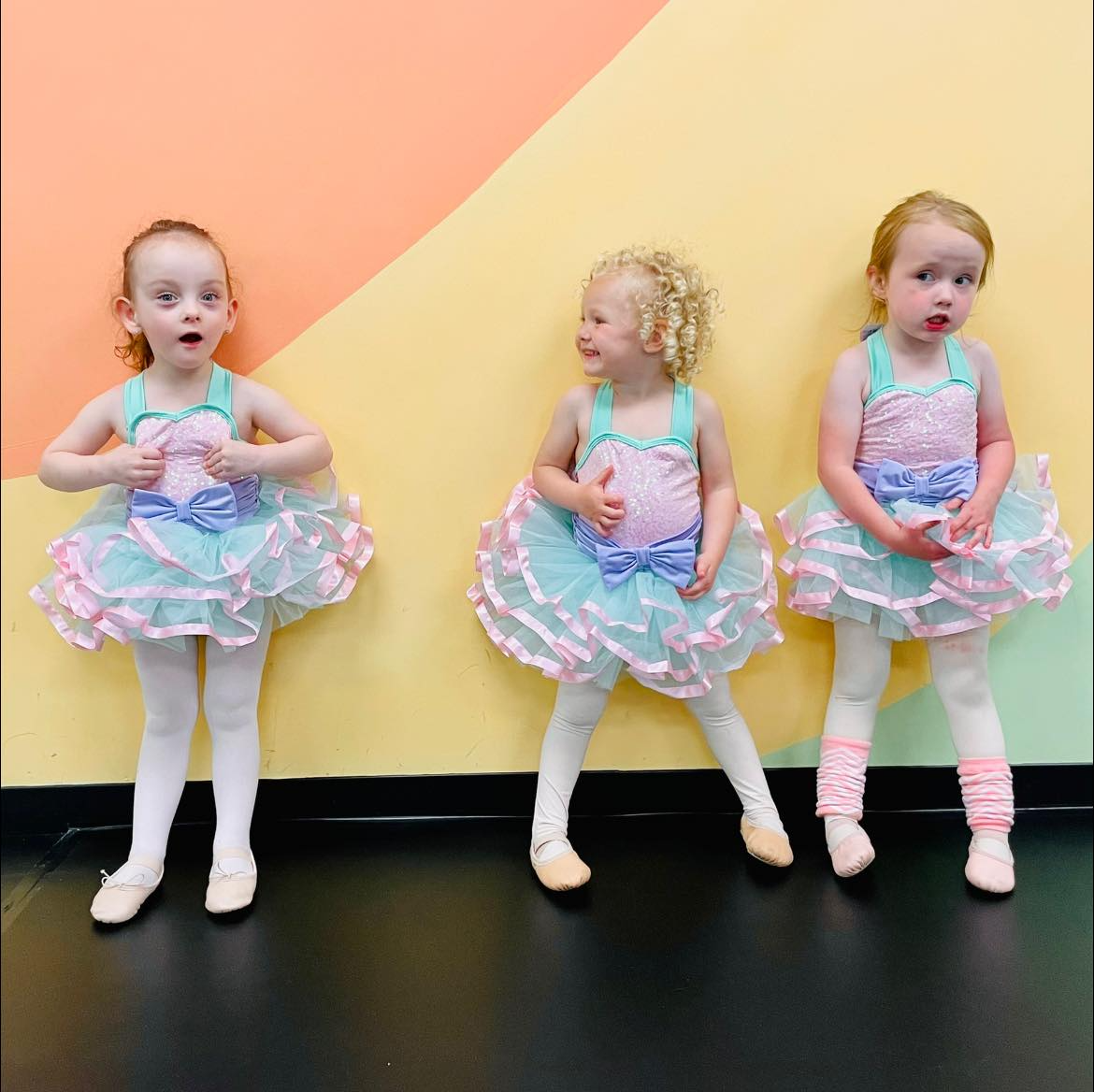a group of girls in dresses