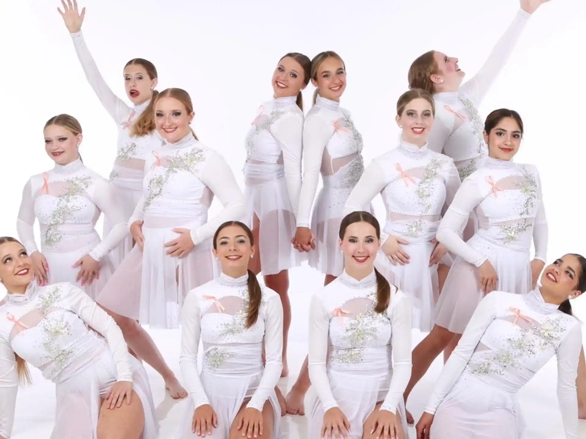 a group of people wearing white outfits