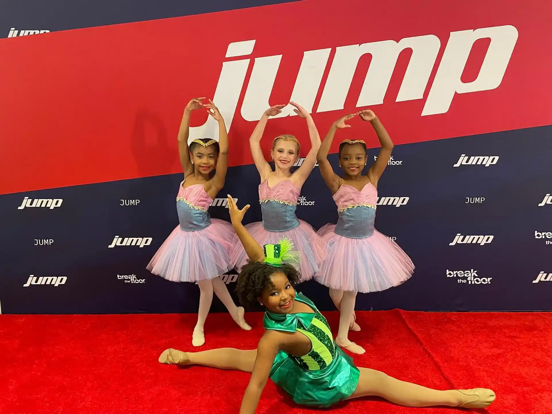 a group of girls in a dance pose on a stage