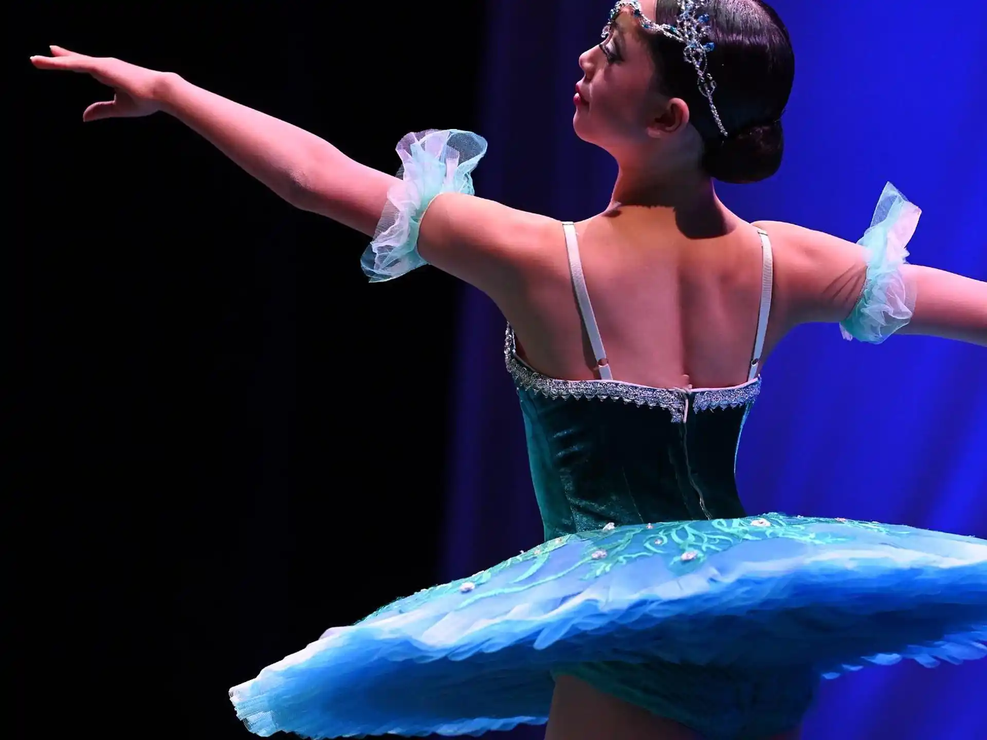 a woman in a blue dress dancing