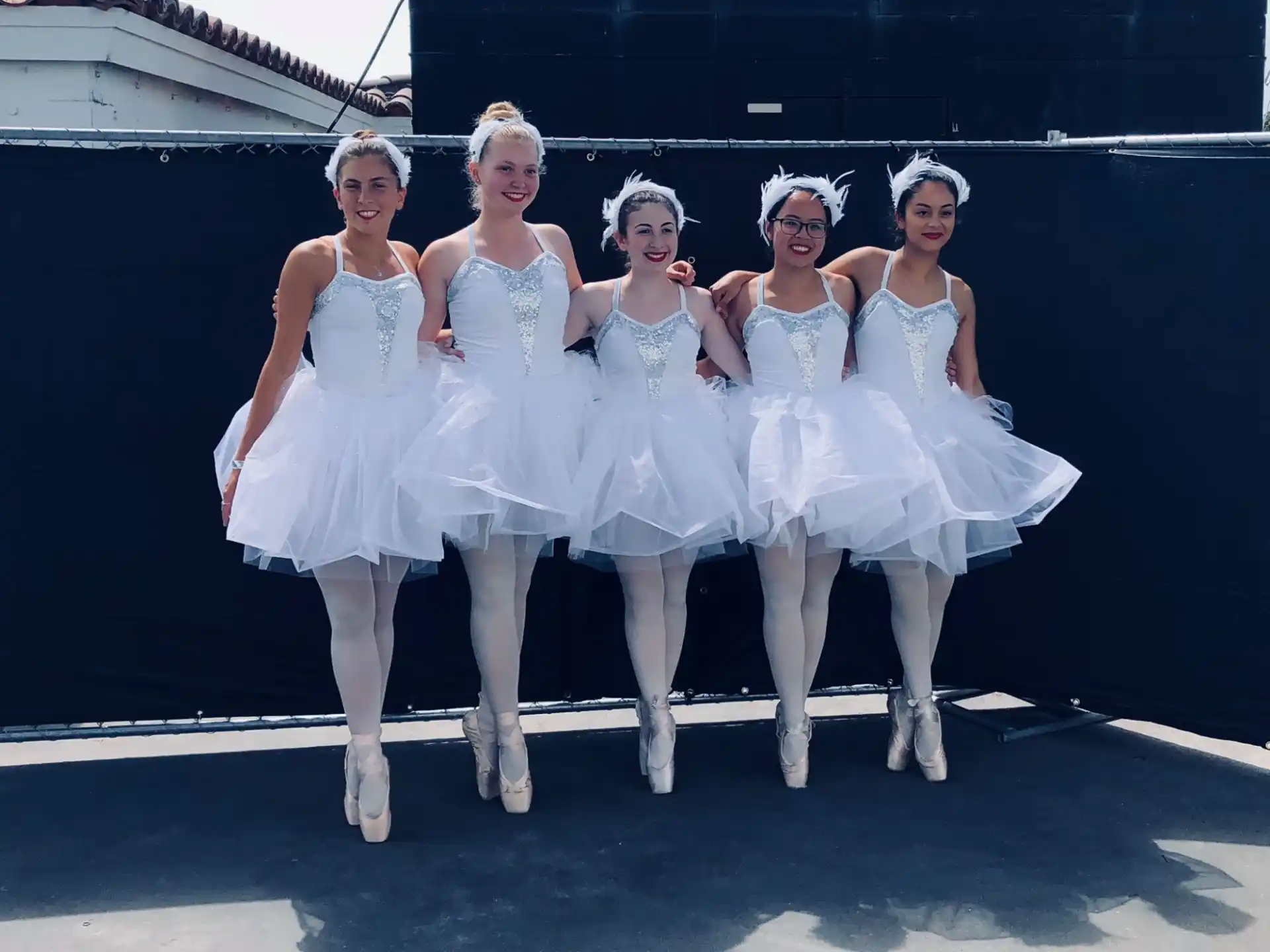 a group of women in white dresses