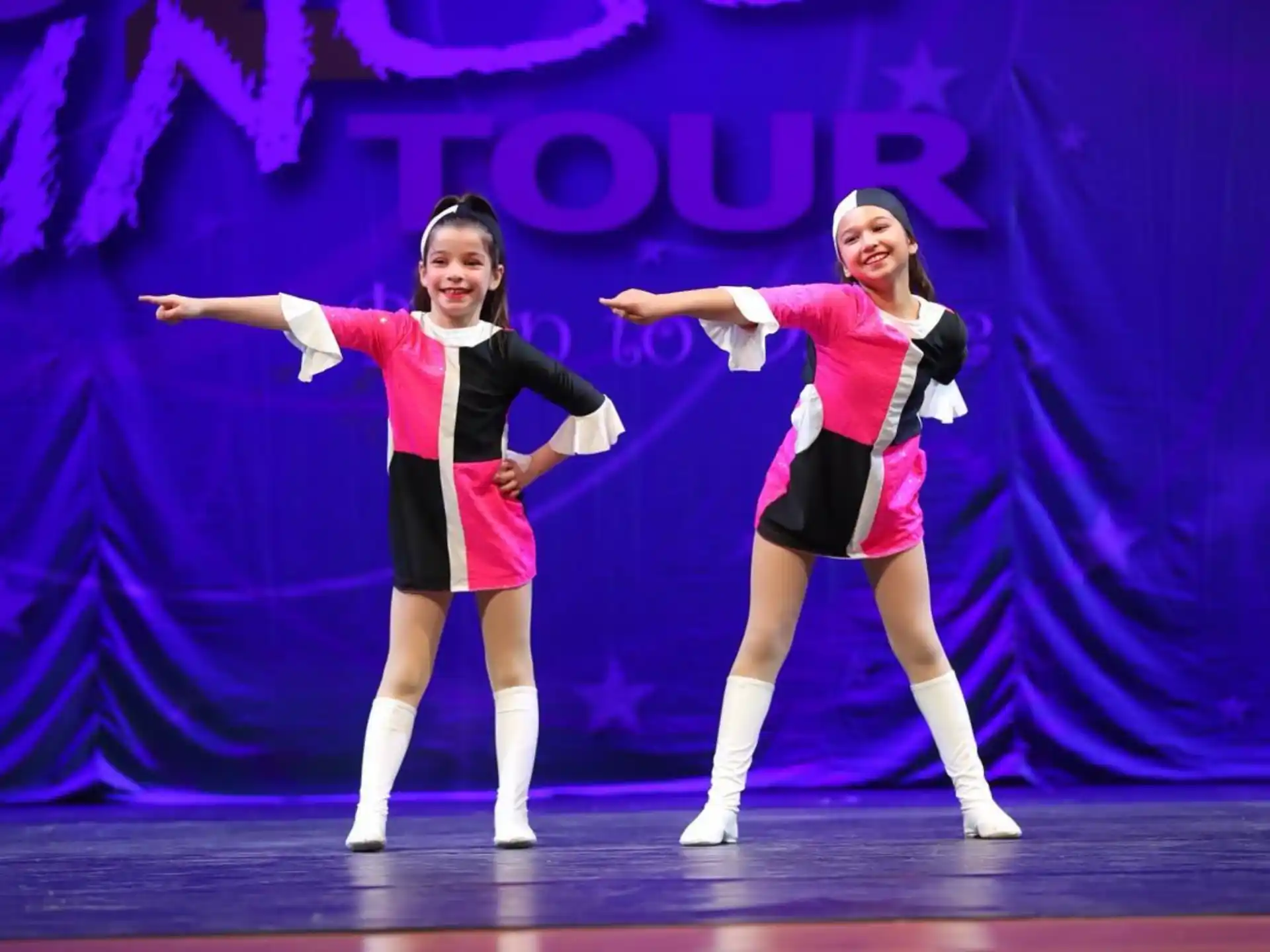 two women dancing on a stage