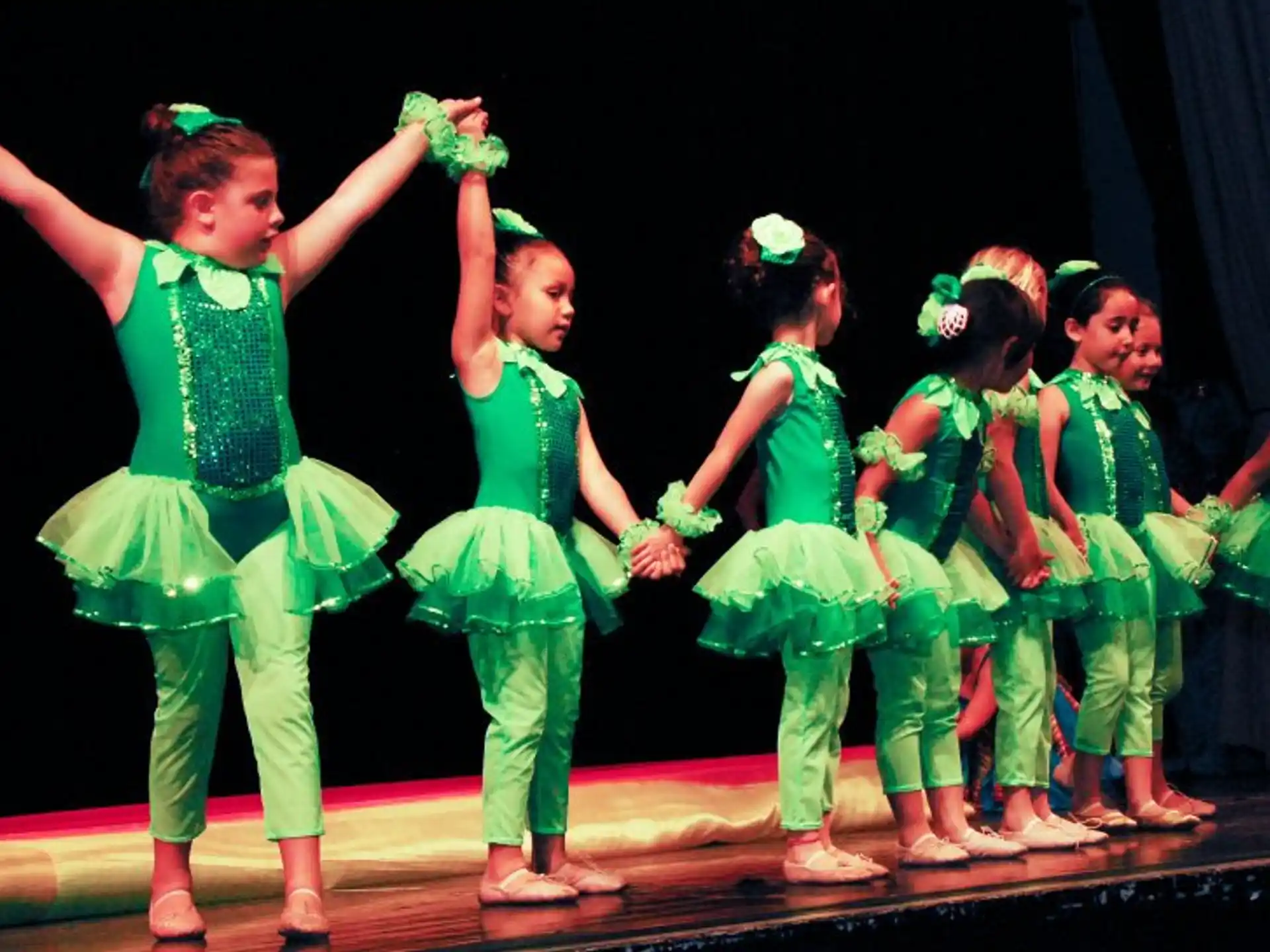 a group of children performing on a stage