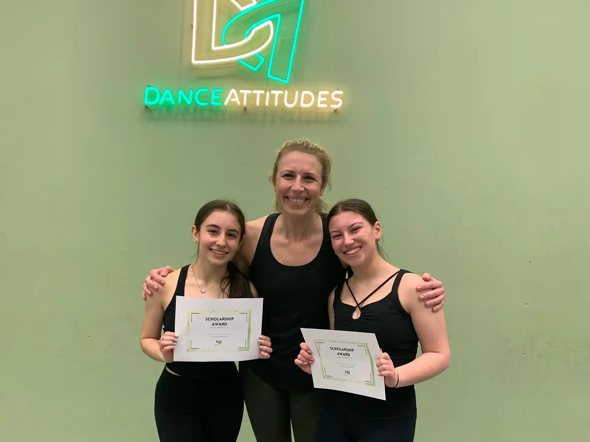 a group of people holding certificates