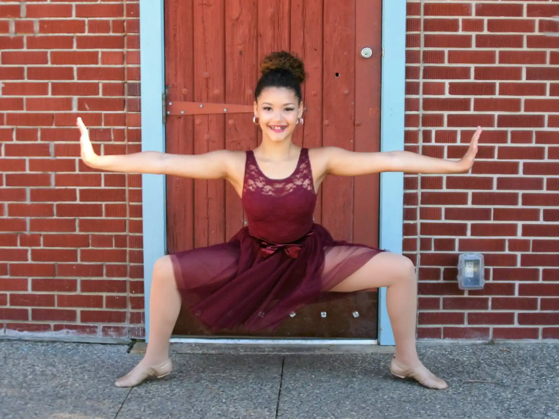 a woman posing in front of a door