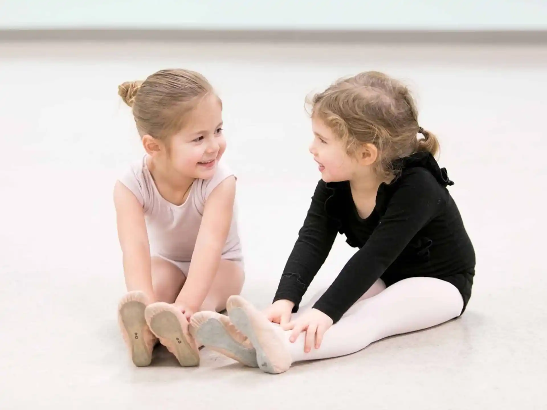 a woman and a child sitting on the ground