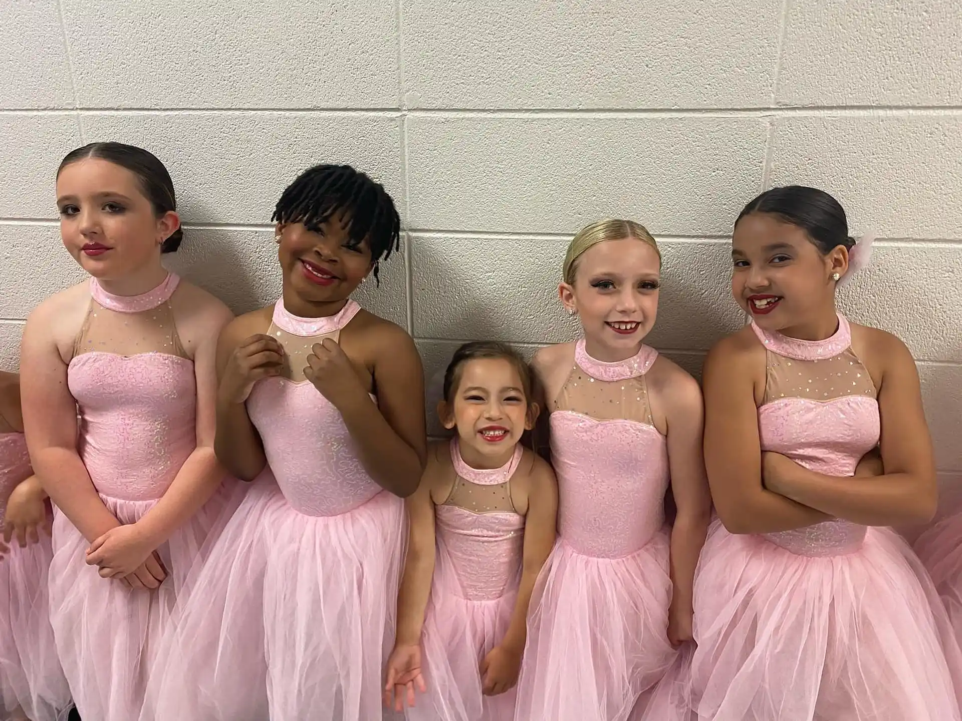 a group of girls in dresses