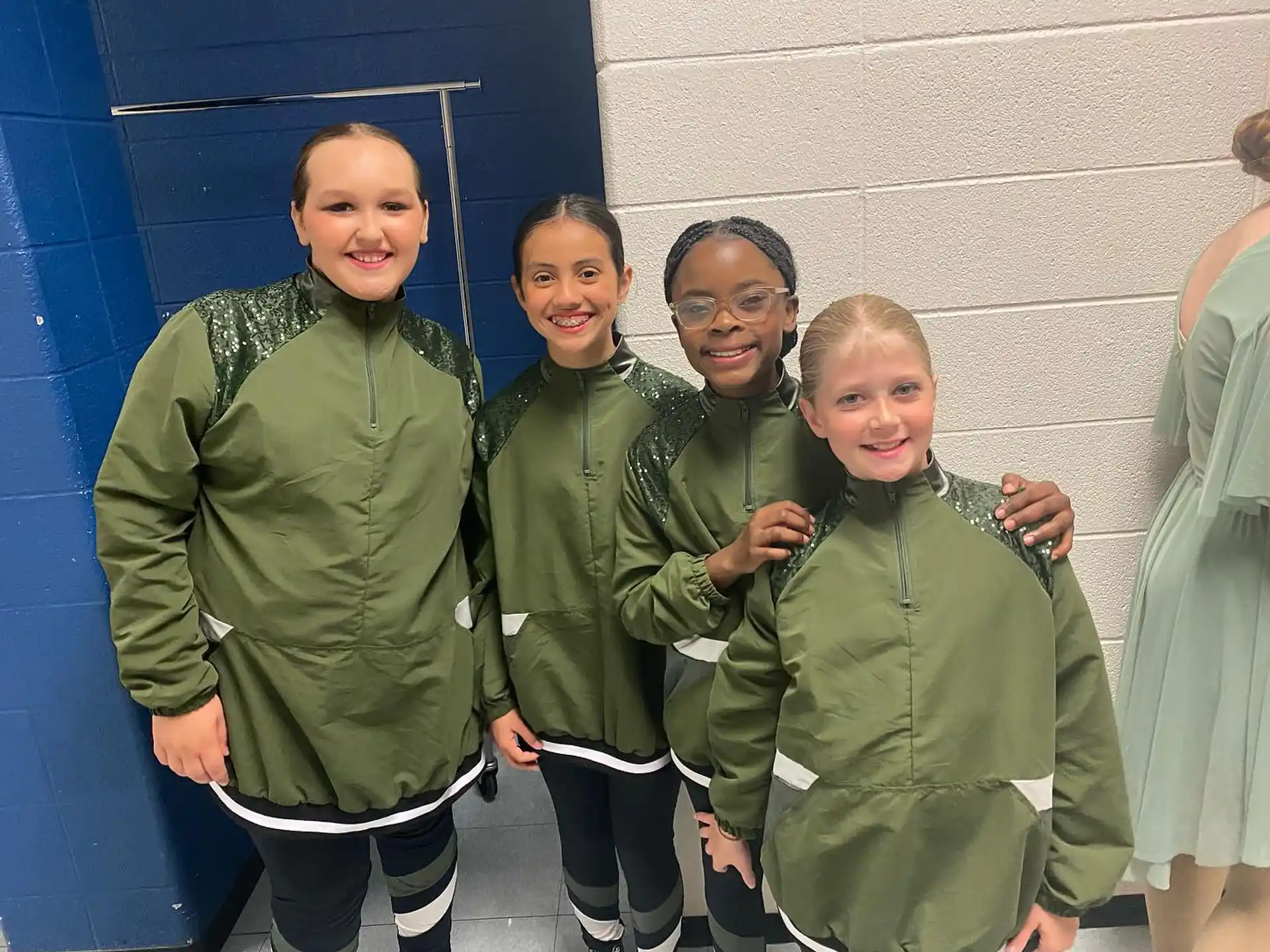 a group of people in green uniforms