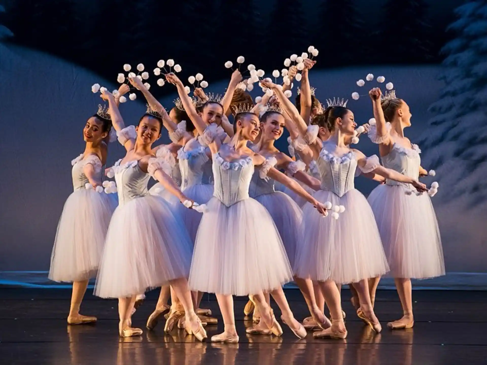 a group of girls wearing white dresses and holding flowers