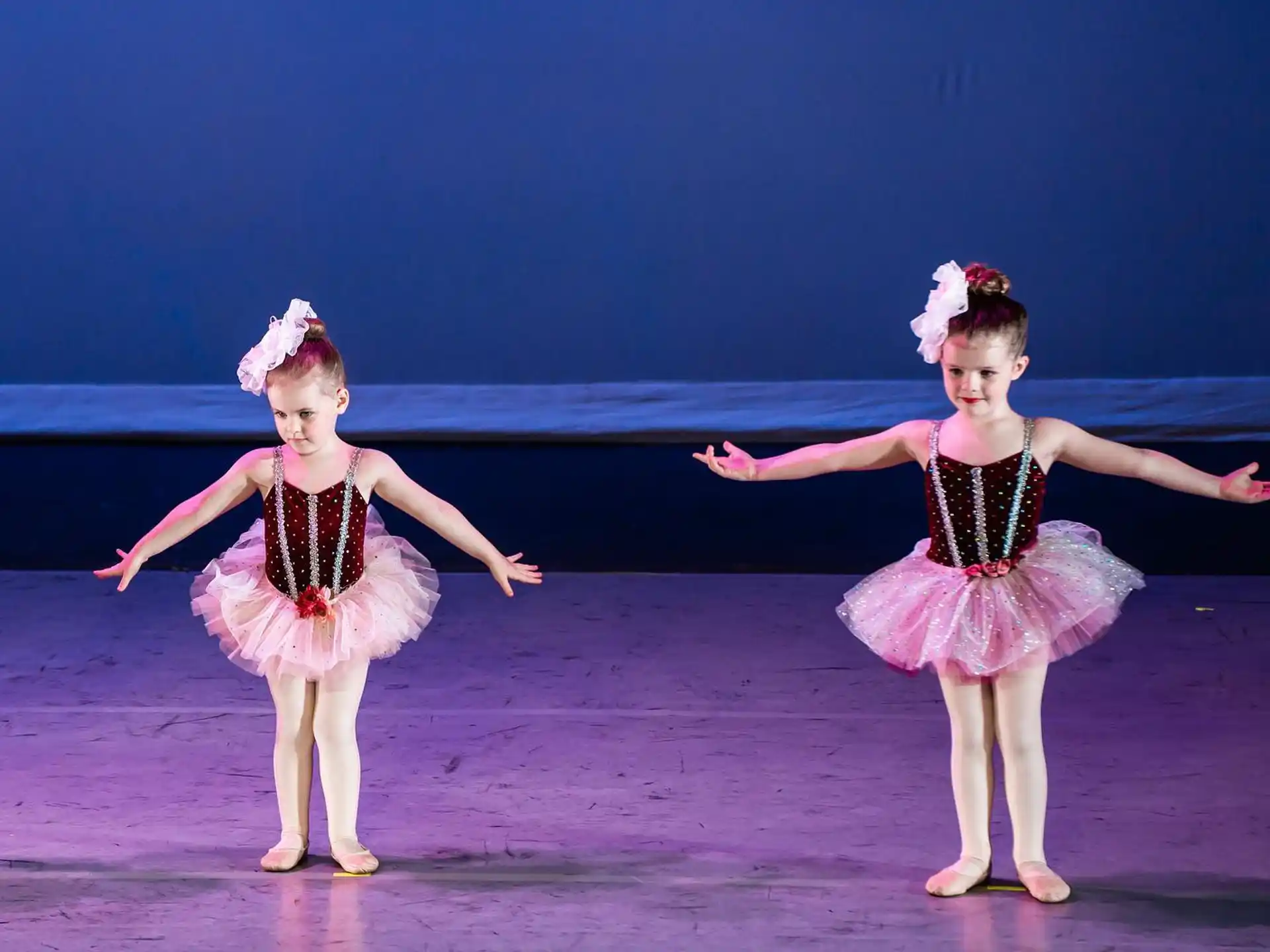 two girls wearing dresses and dancing
