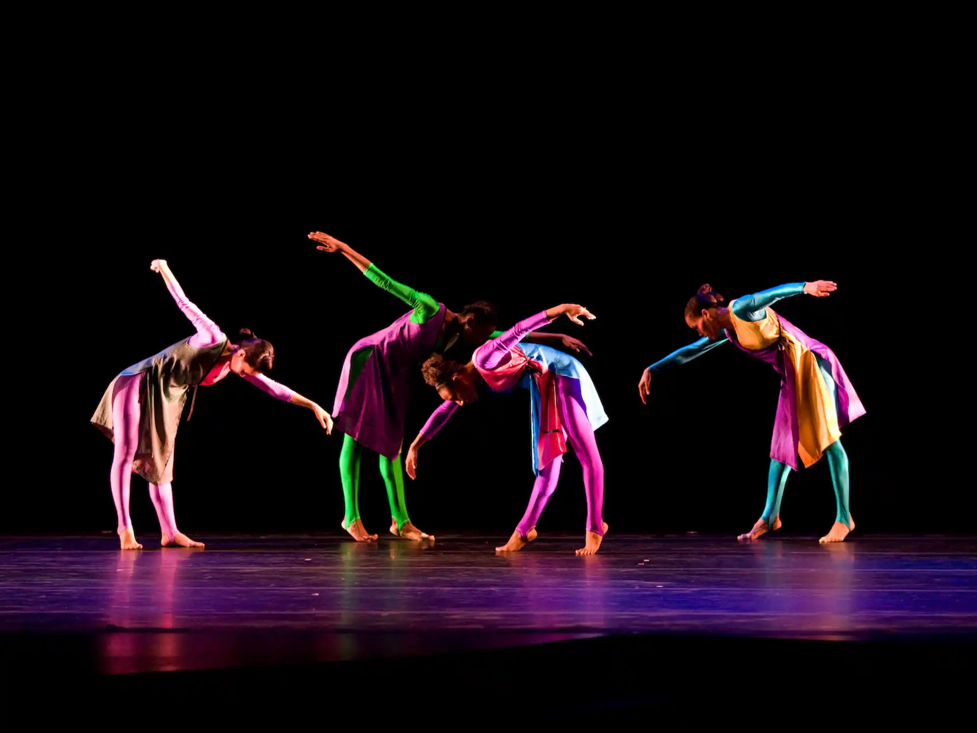 a group of people dancing on a stage