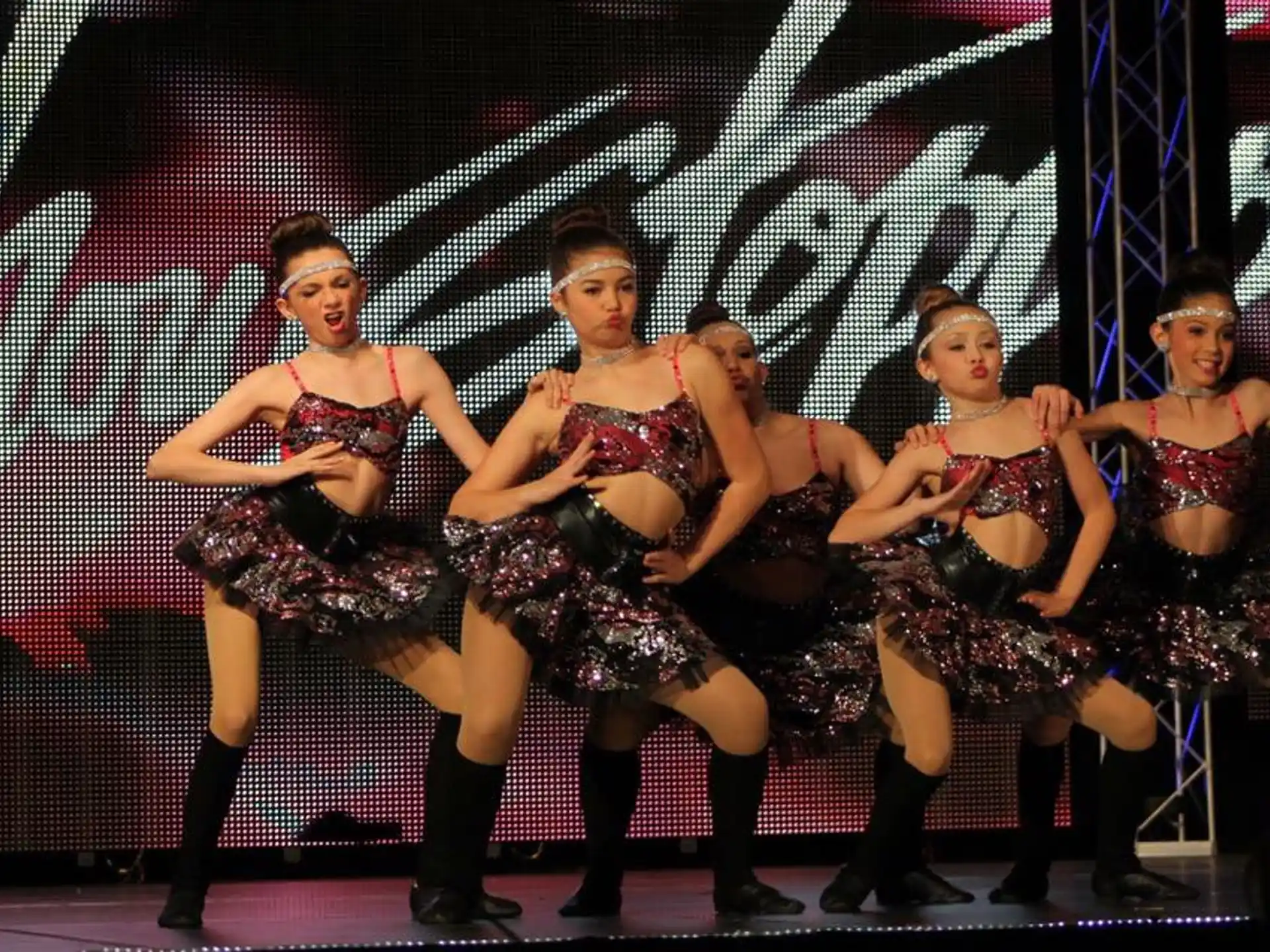 a group of women dancing on a stage