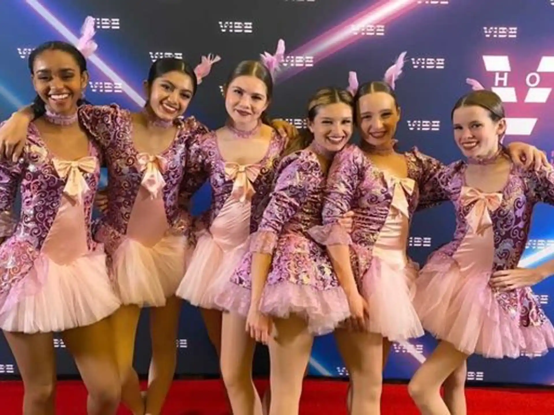 a group of women in dresses