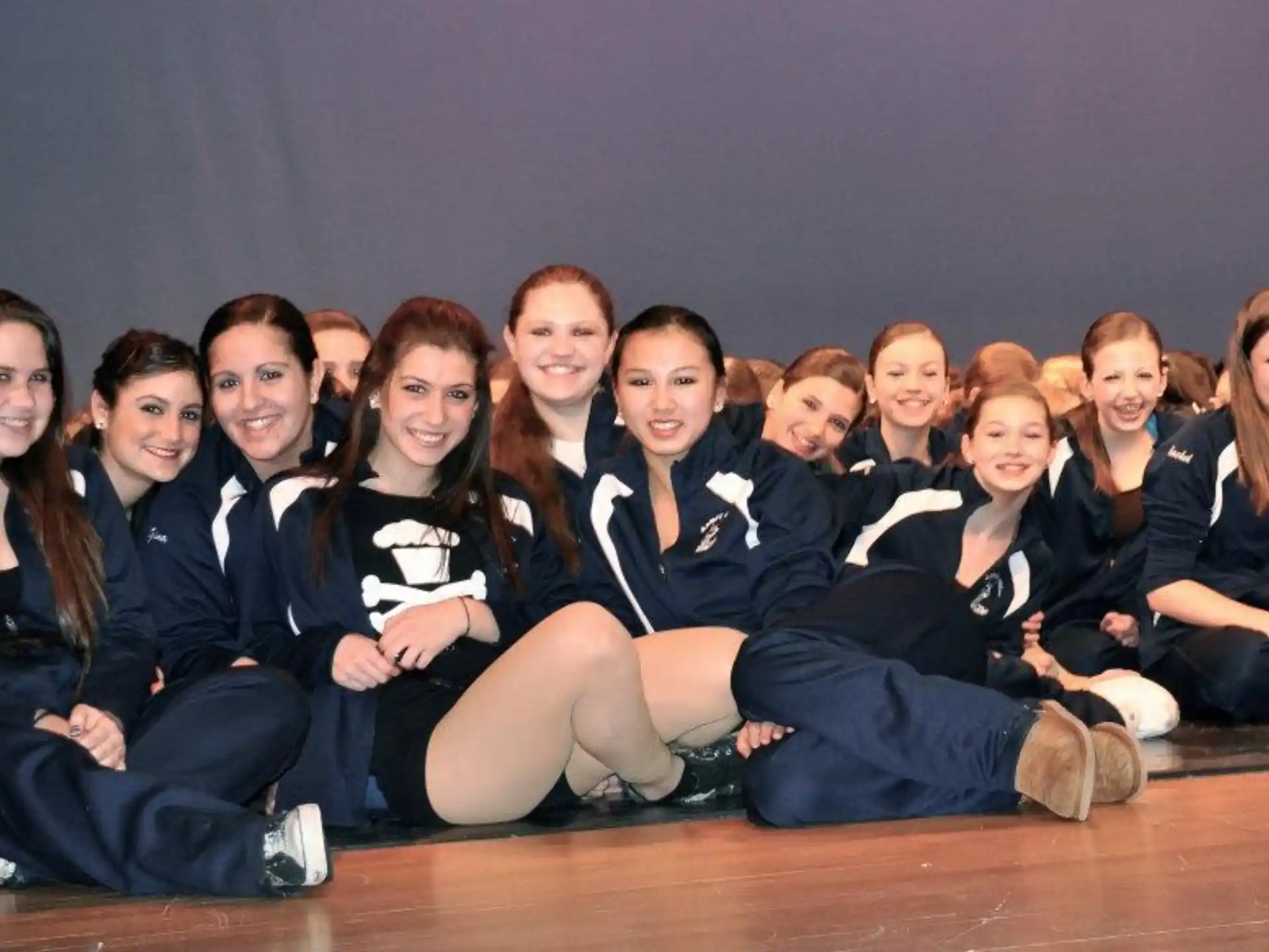 a group of people sitting together smiling