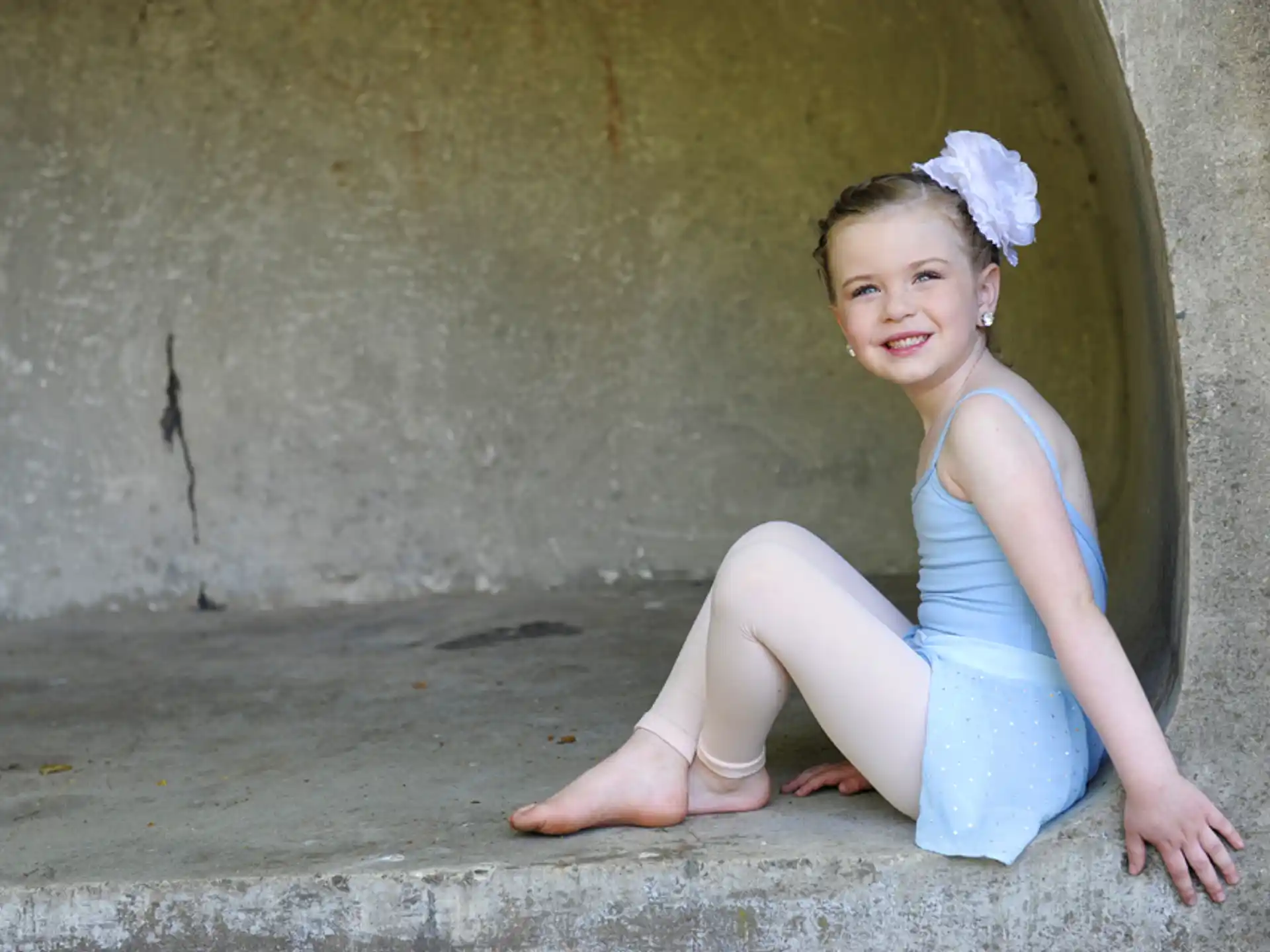 a girl sitting on a ledge