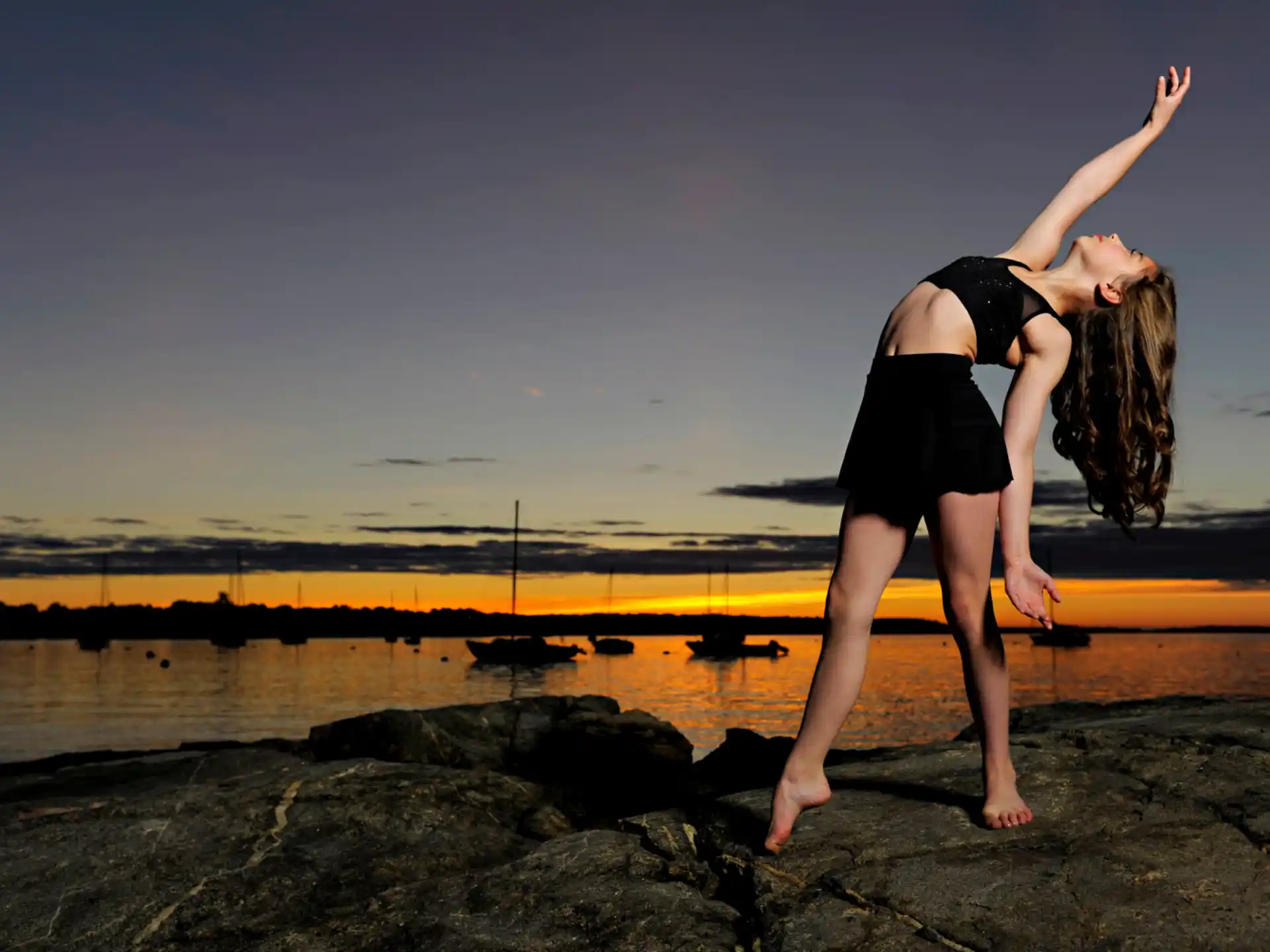 a woman standing on a rock