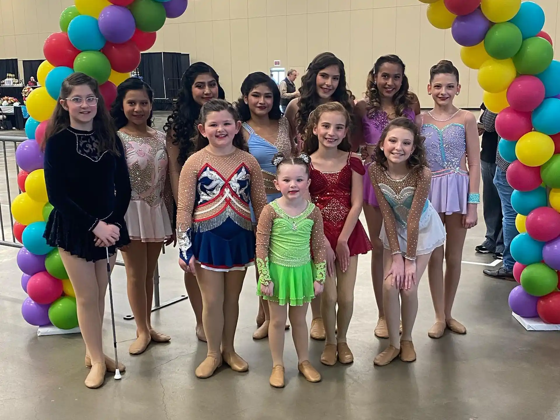 a group of girls posing for a photo with balloons