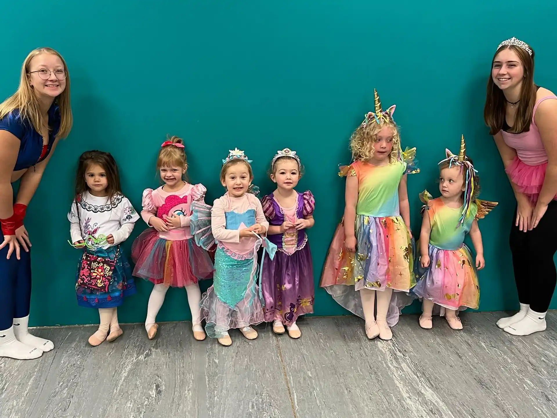 a group of women in colorful dresses