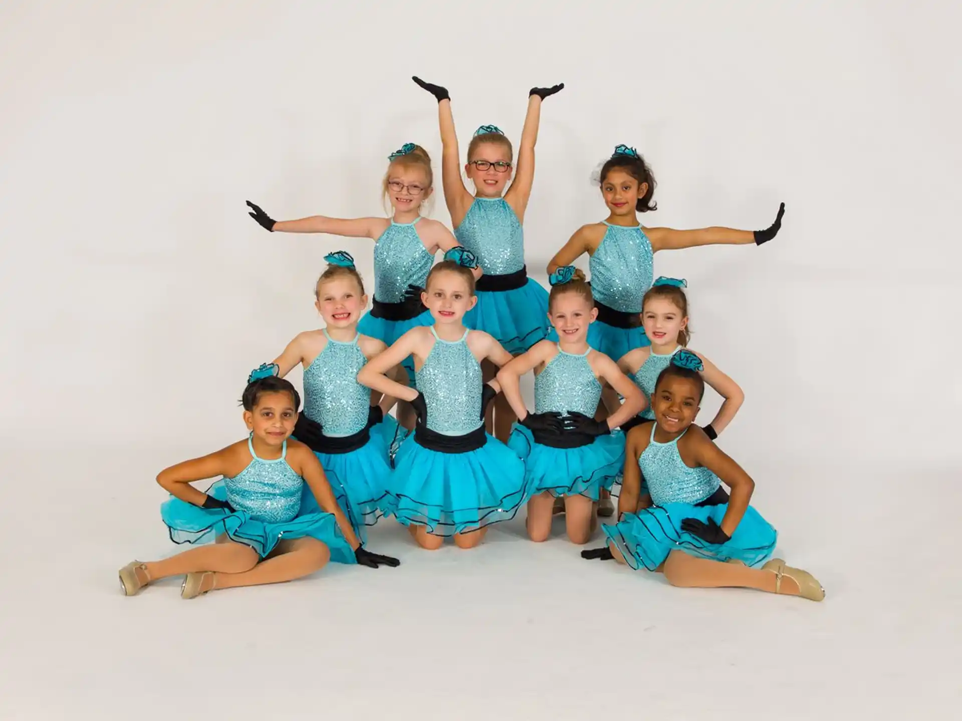 a group of women in blue dresses