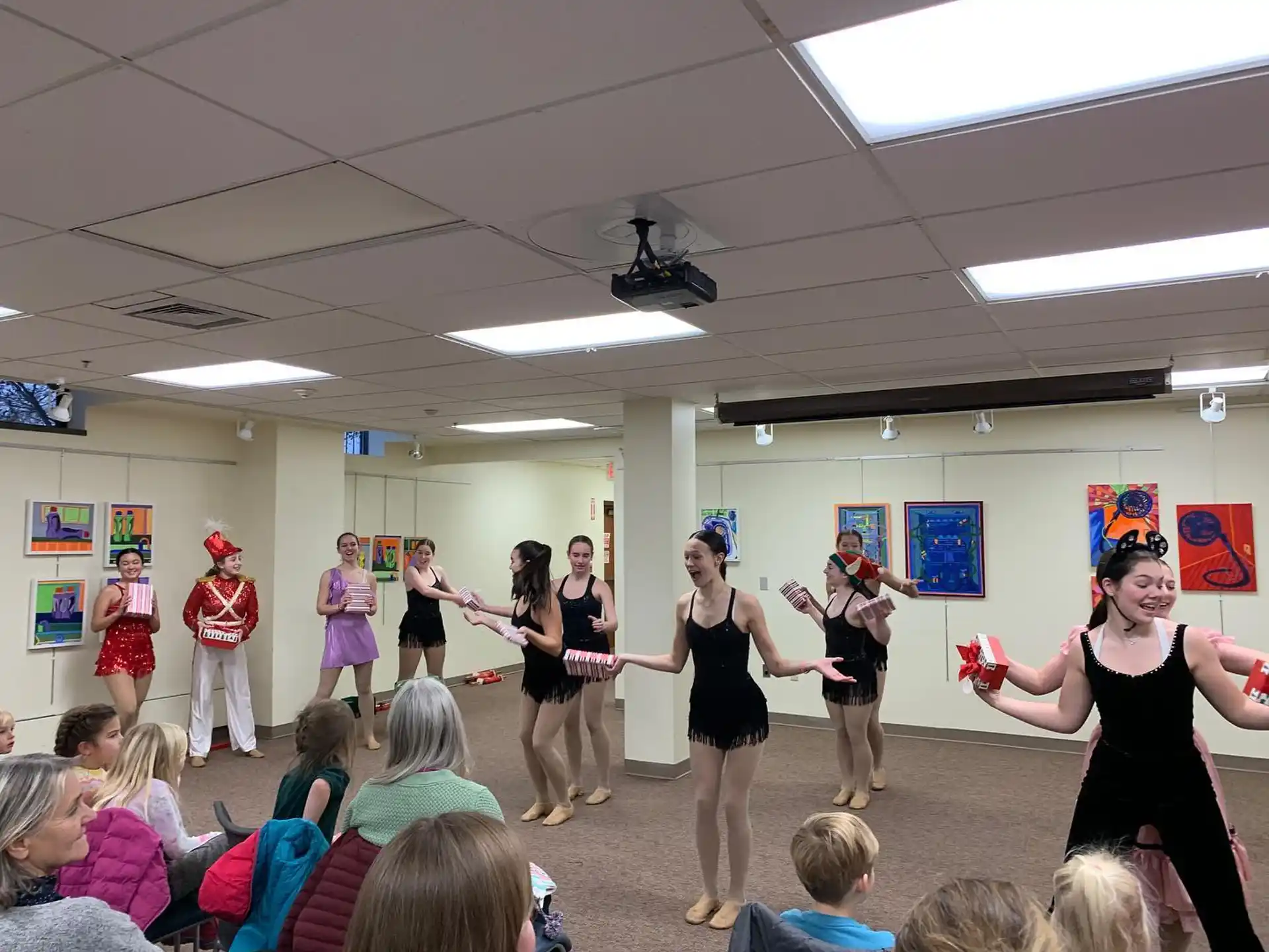 a group of people dancing in a room with a crowd watching