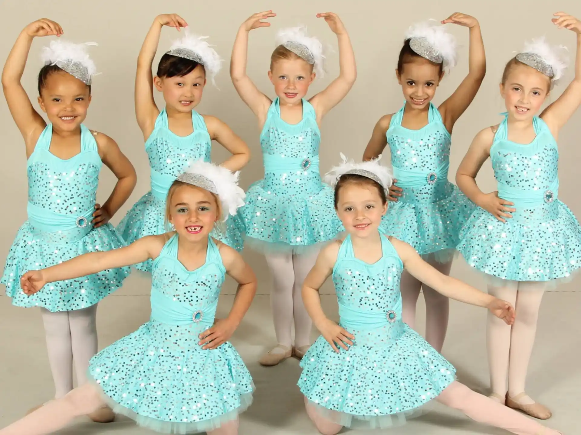 a group of girls in blue dresses