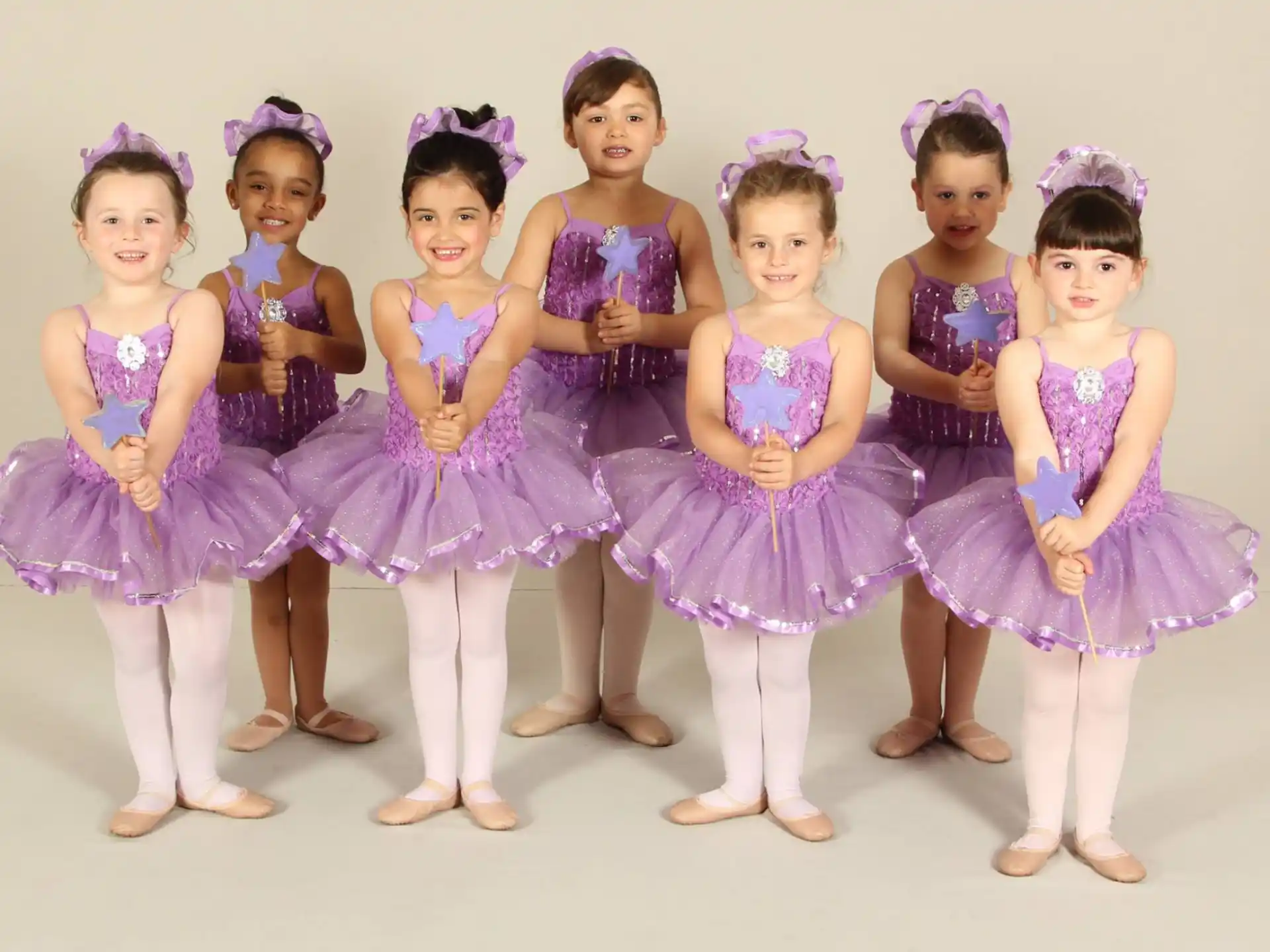 a group of girls in dresses