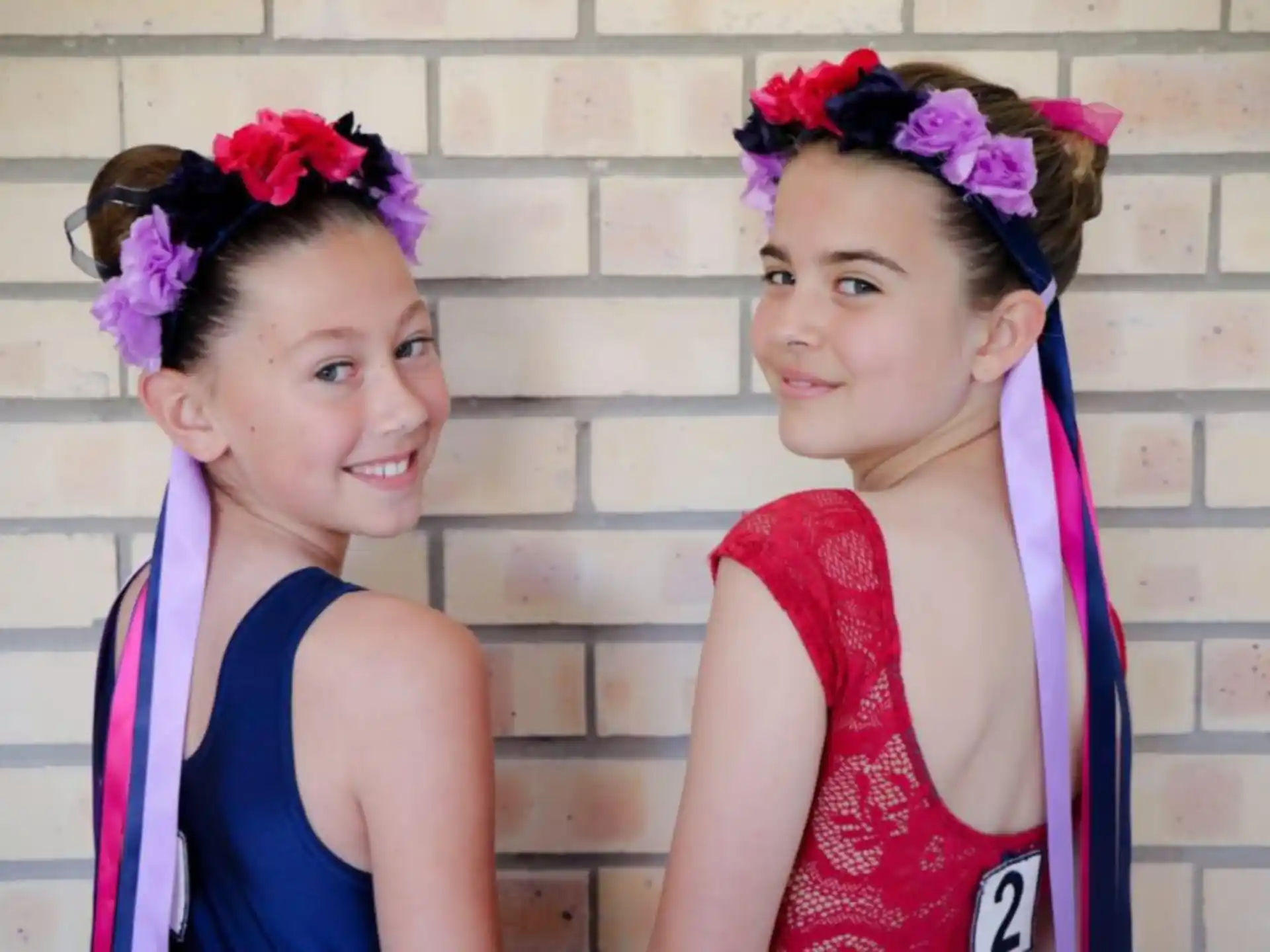 a couple of girls wearing clothing