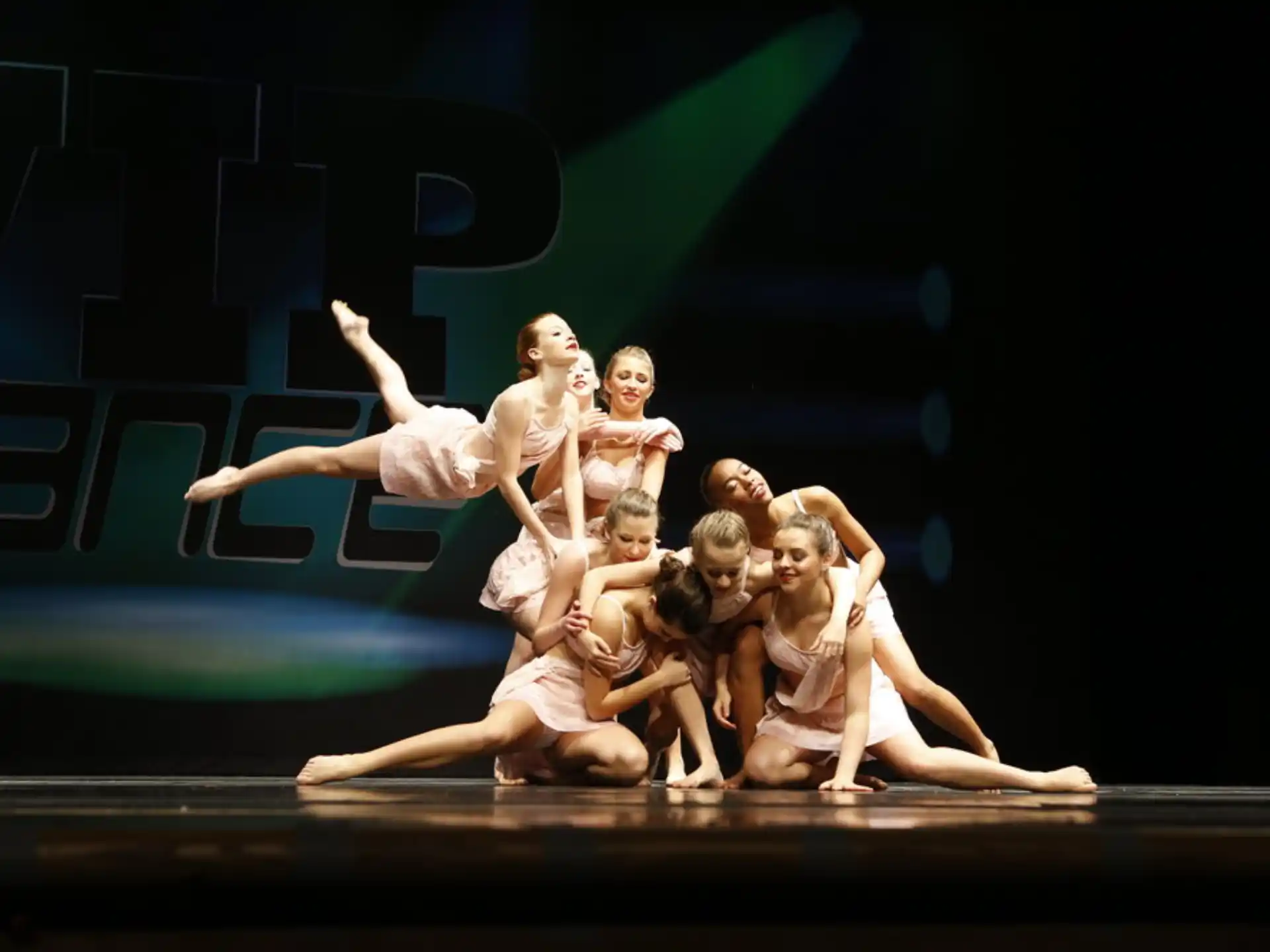 a group of people dancing on a stage