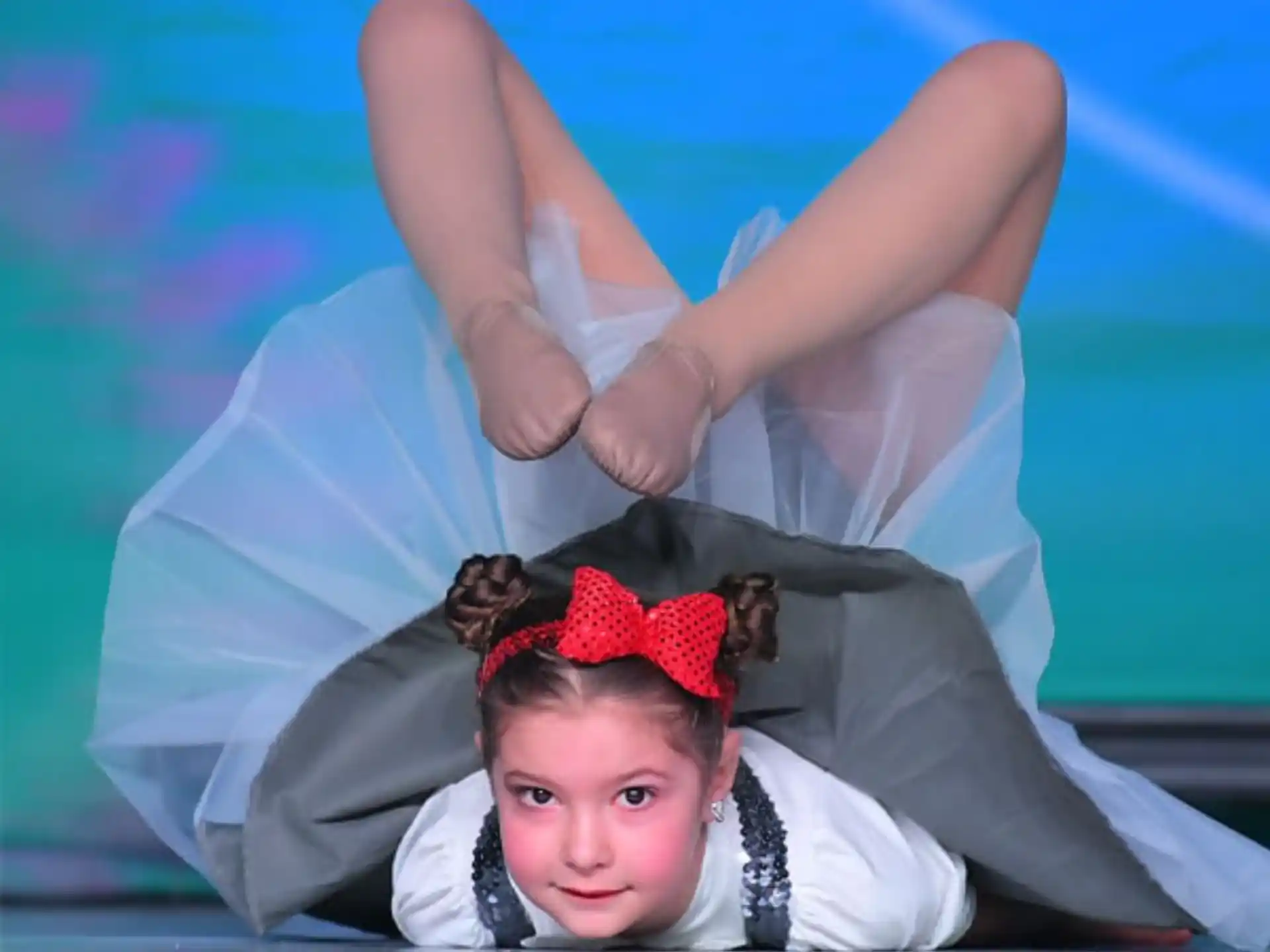 a woman lying on her back on a stage