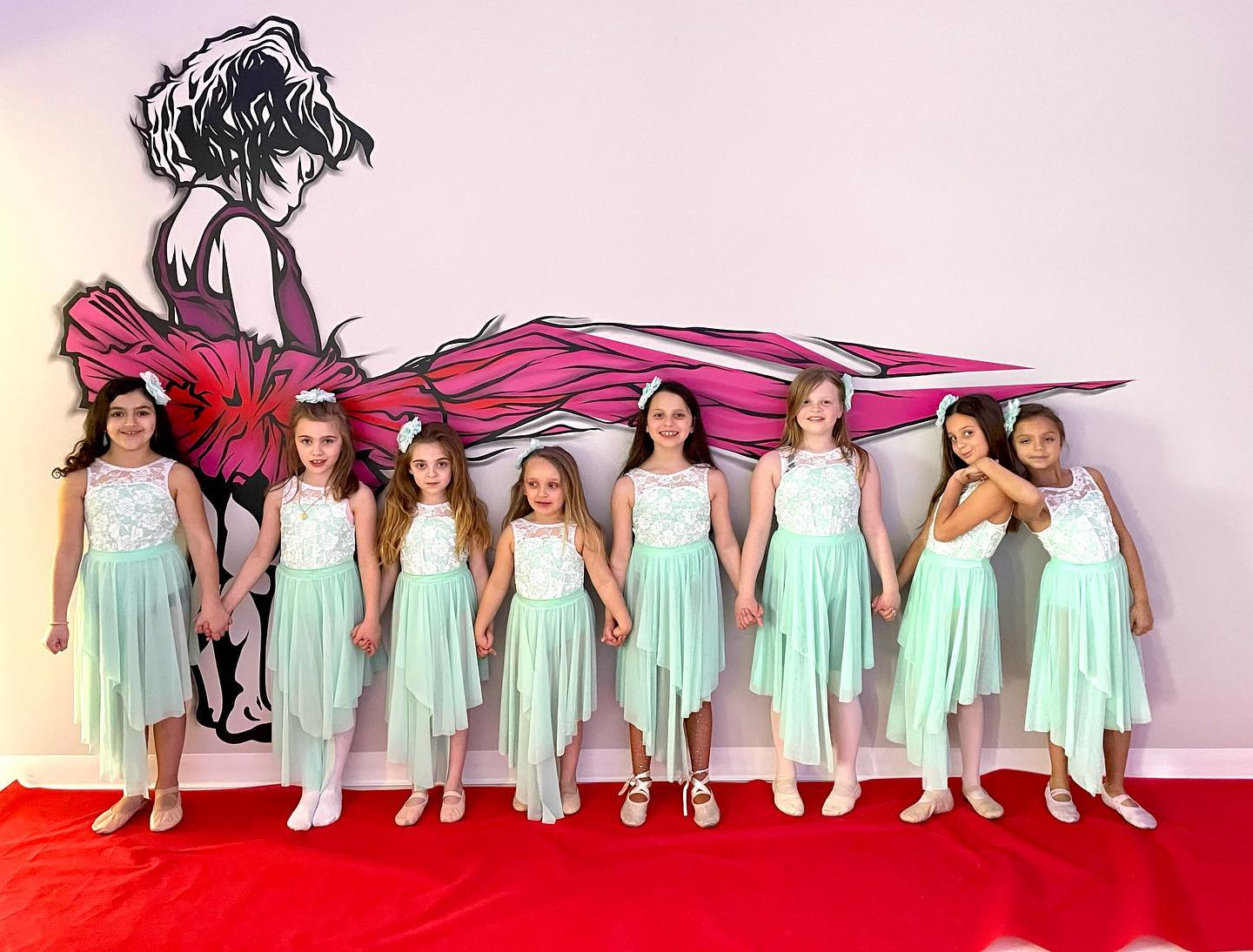 a group of girls in dresses