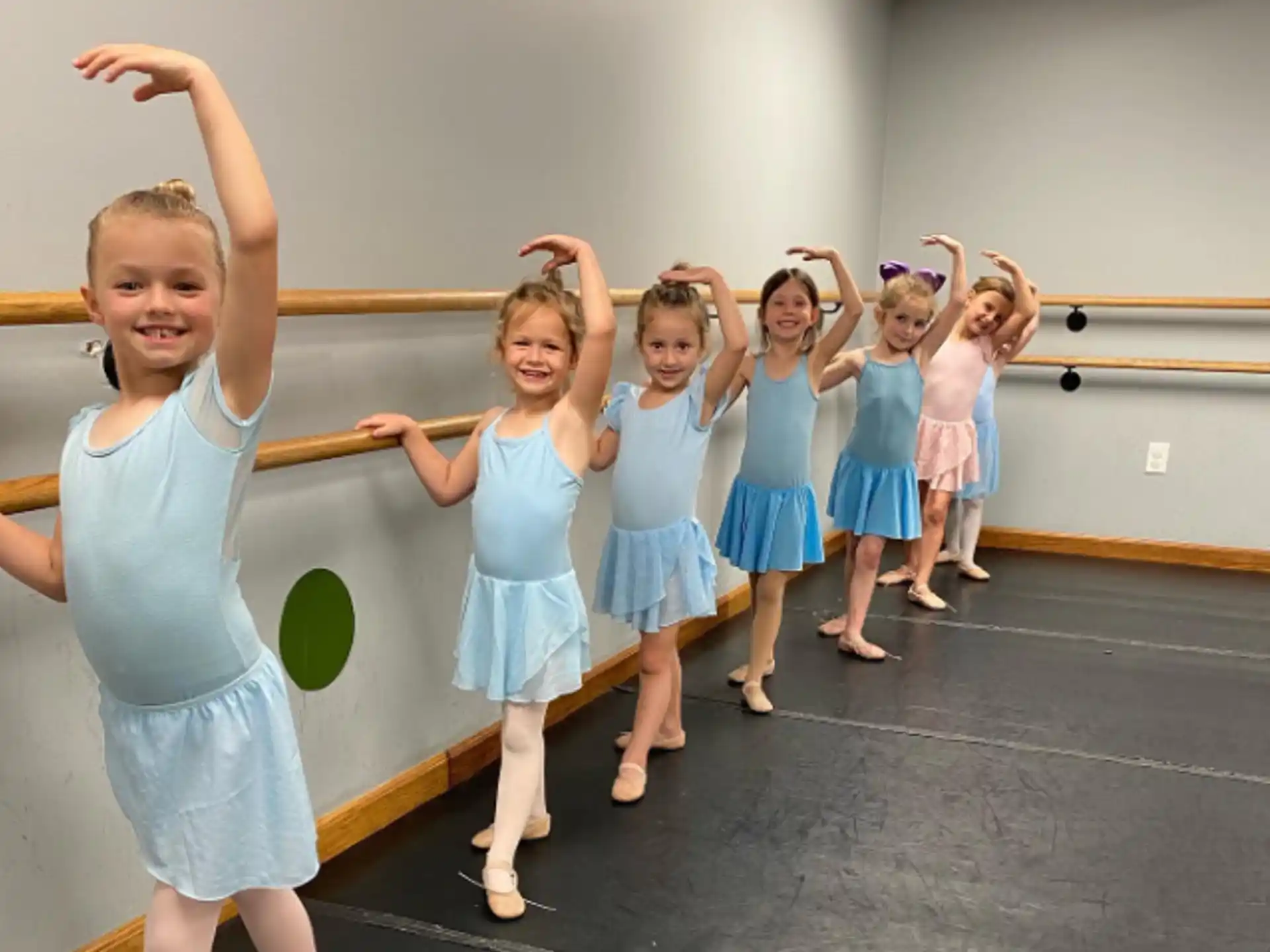a group of girls in blue dresses