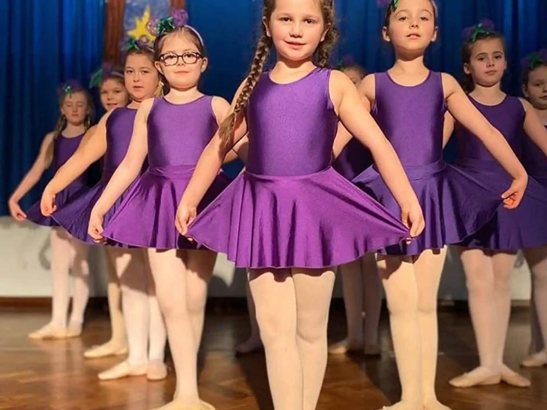 a group of girls in purple dresses