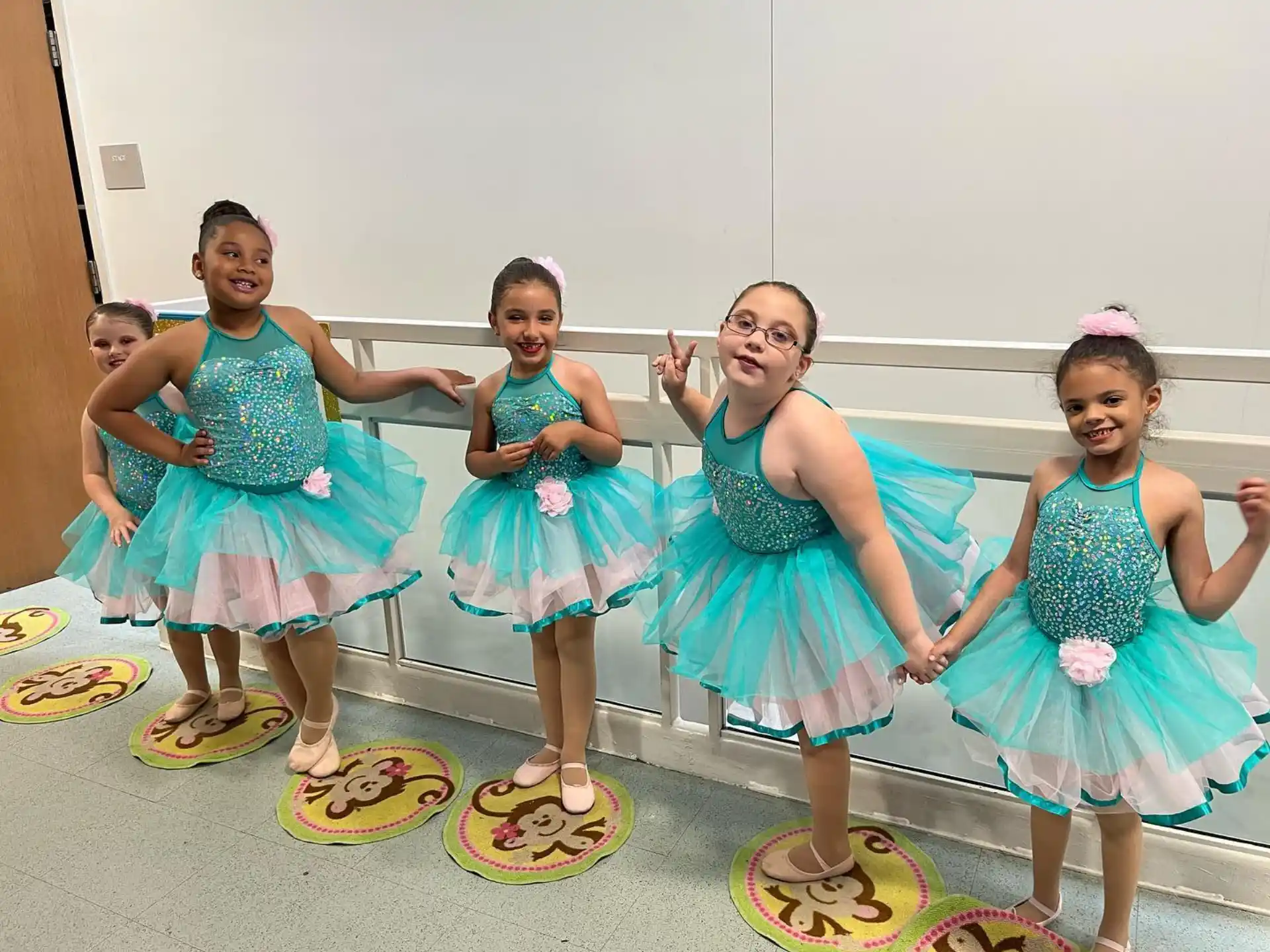 a group of girls in dresses