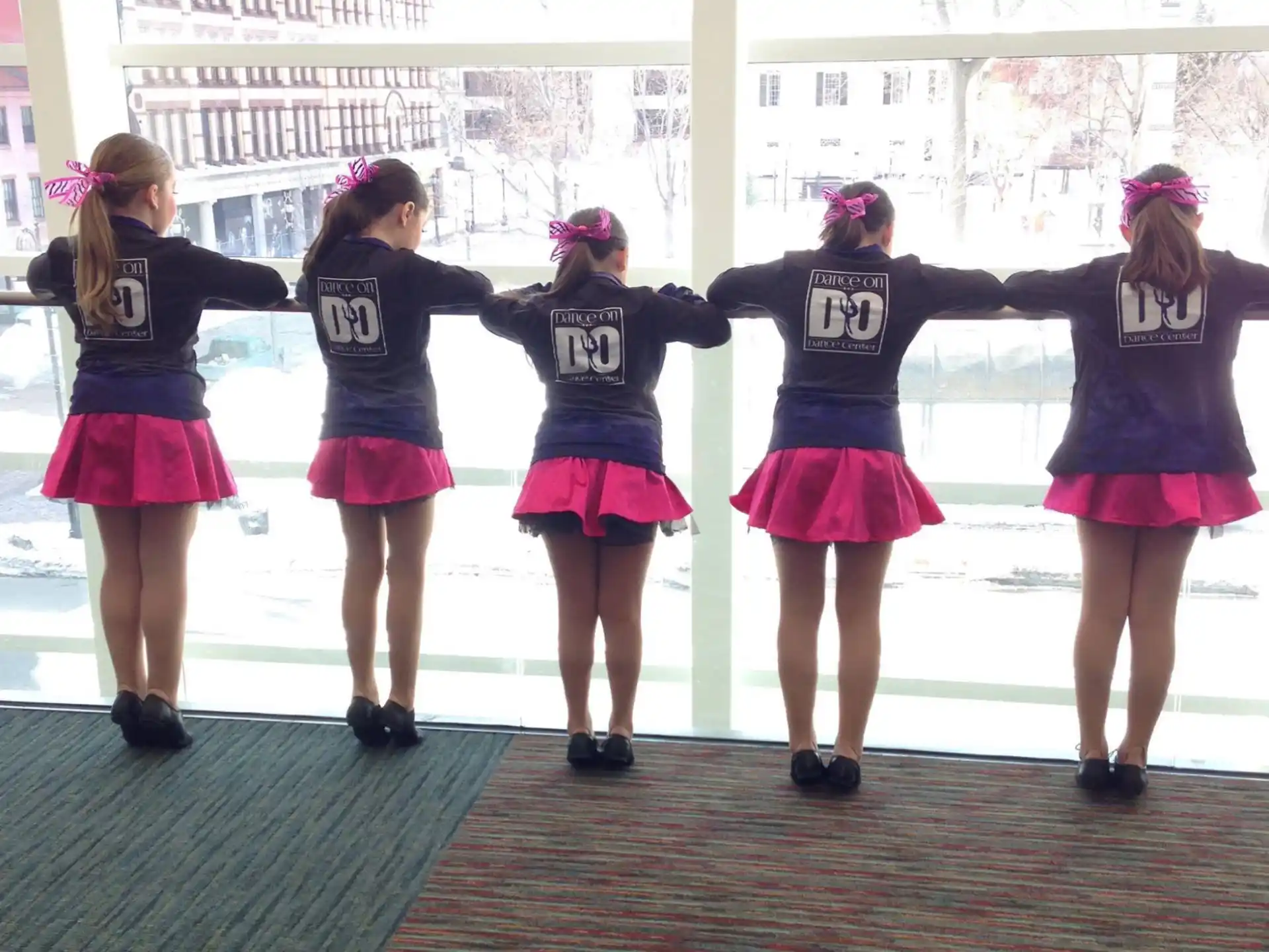 a group of girls wearing matching outfits