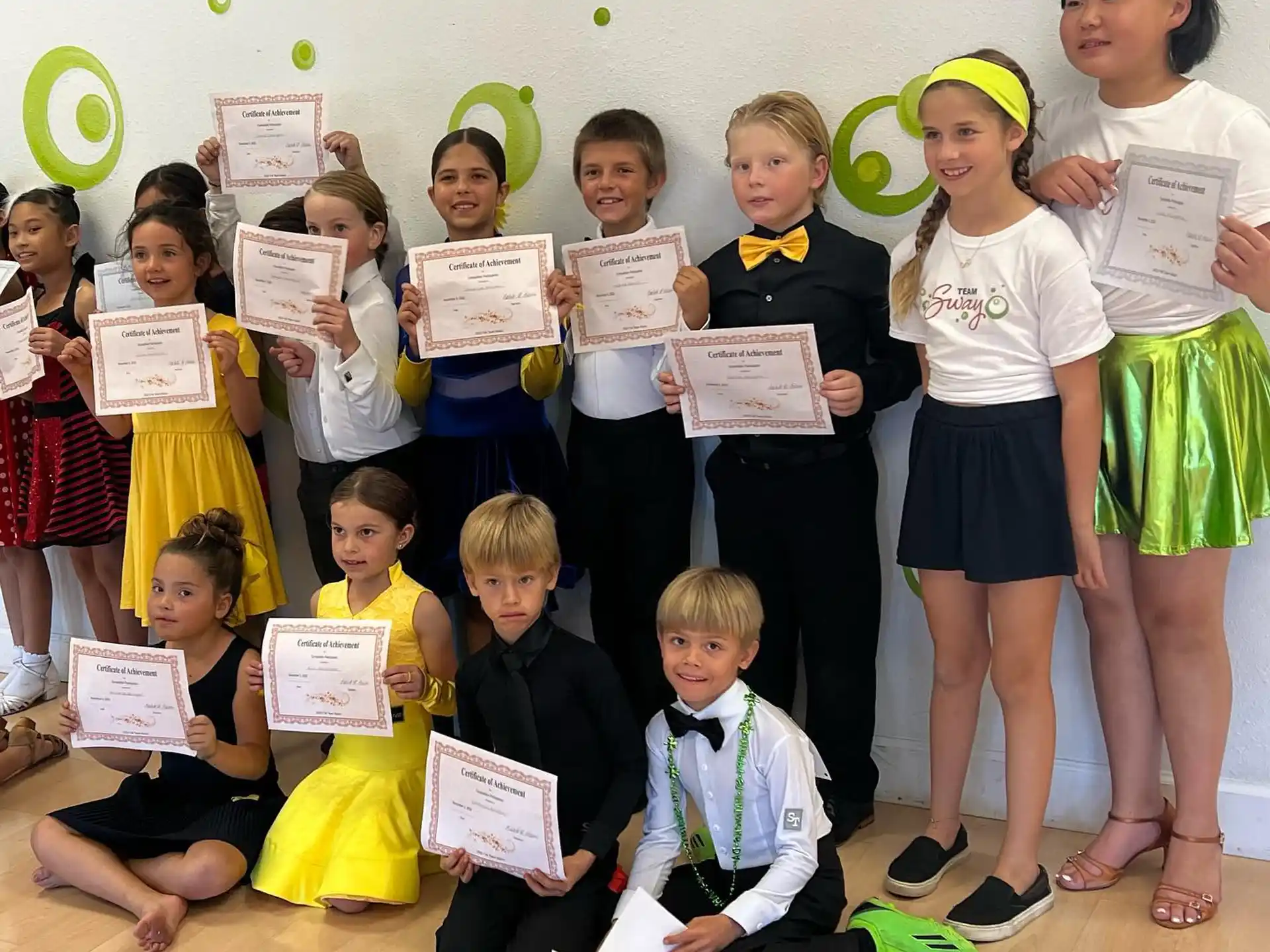 a group of children holding certificates