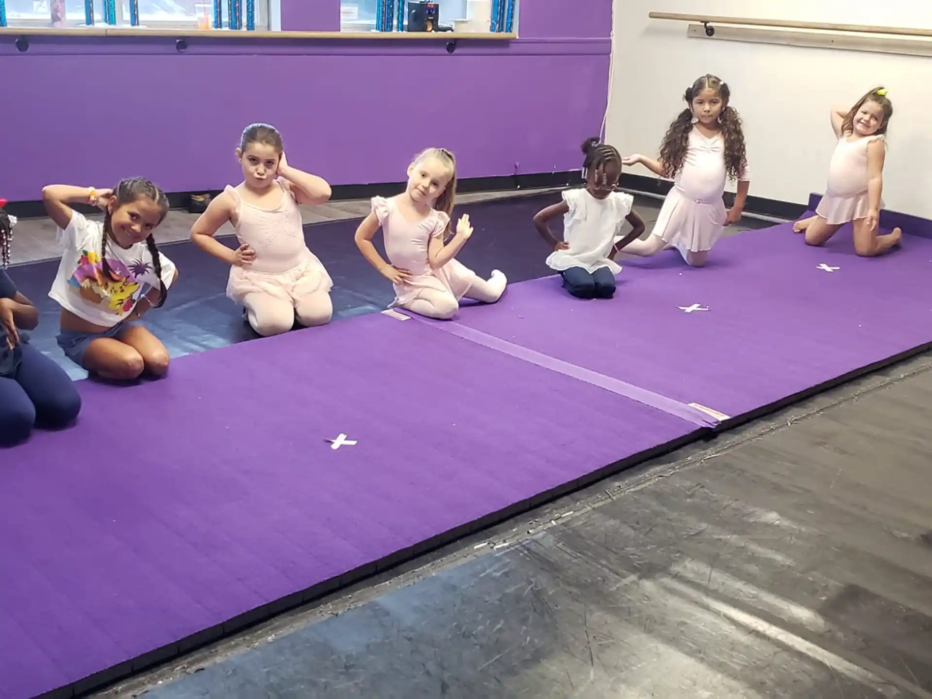 a group of women sitting on a mat