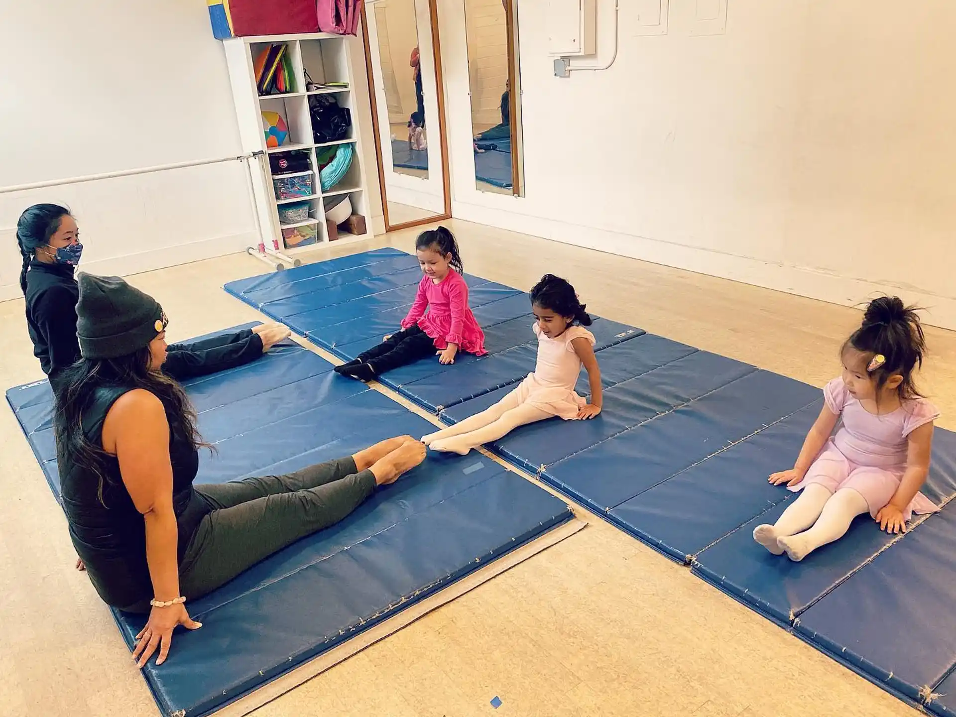 a group of people sitting on a mat