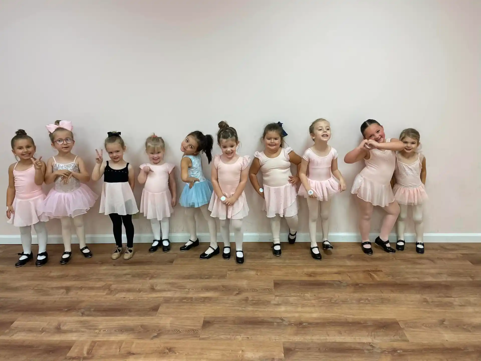a group of girls in white dresses