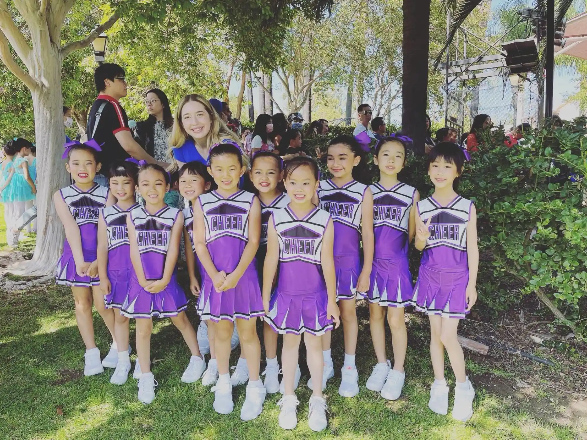 a group of girls in purple and white uniforms standing in a line