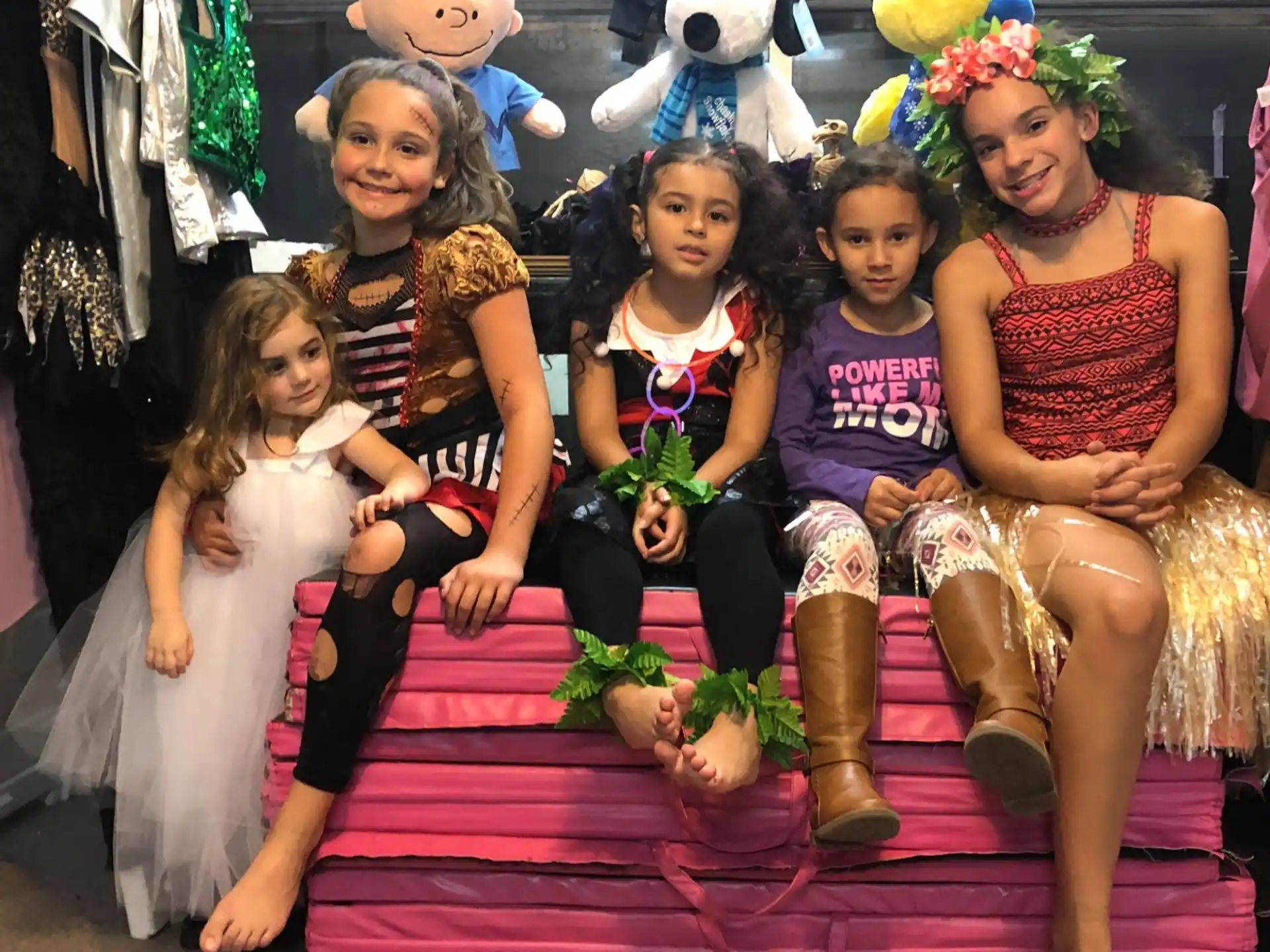 a group of people sitting on a couch posing for the camera