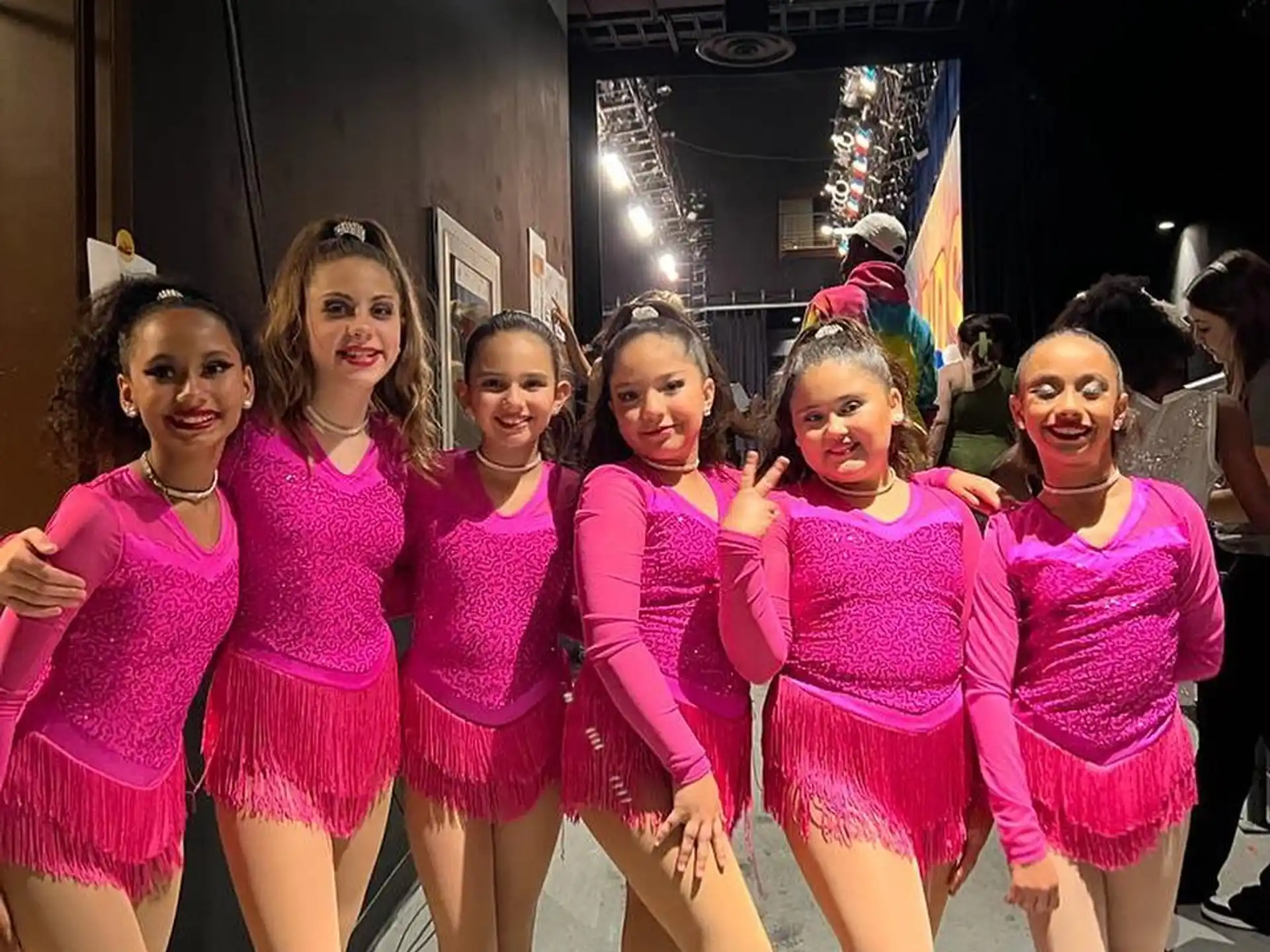 a group of girls in pink dresses