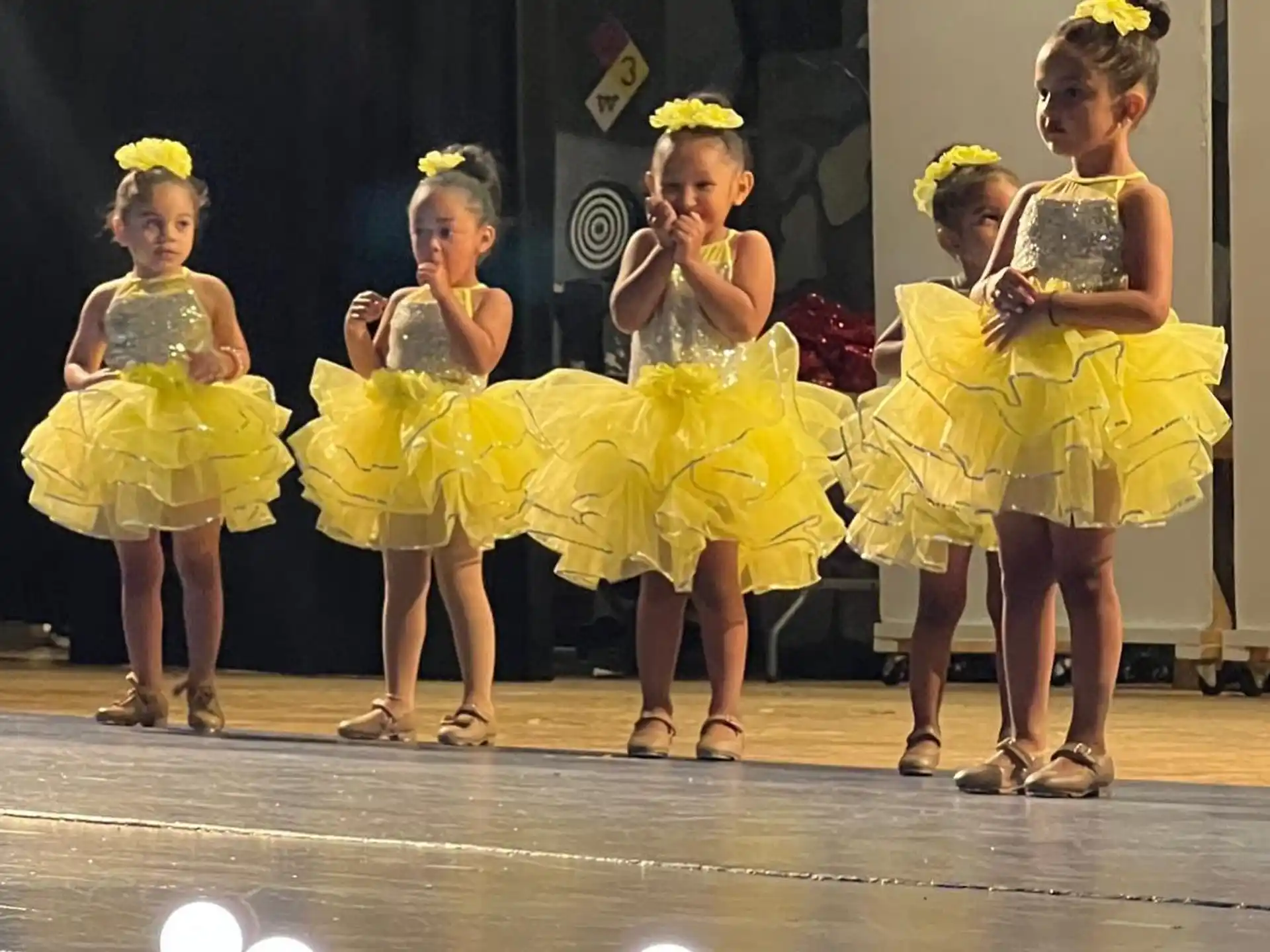 a group of women in yellow dresses