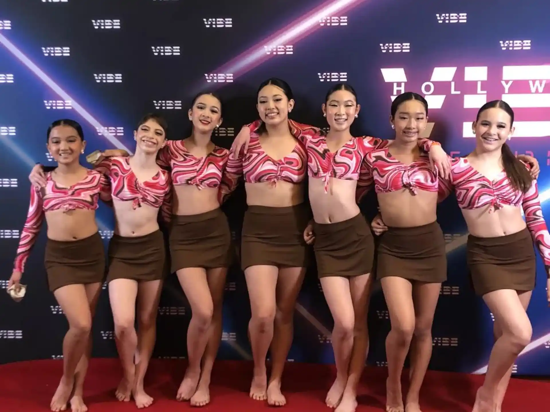 a group of women in matching outfits