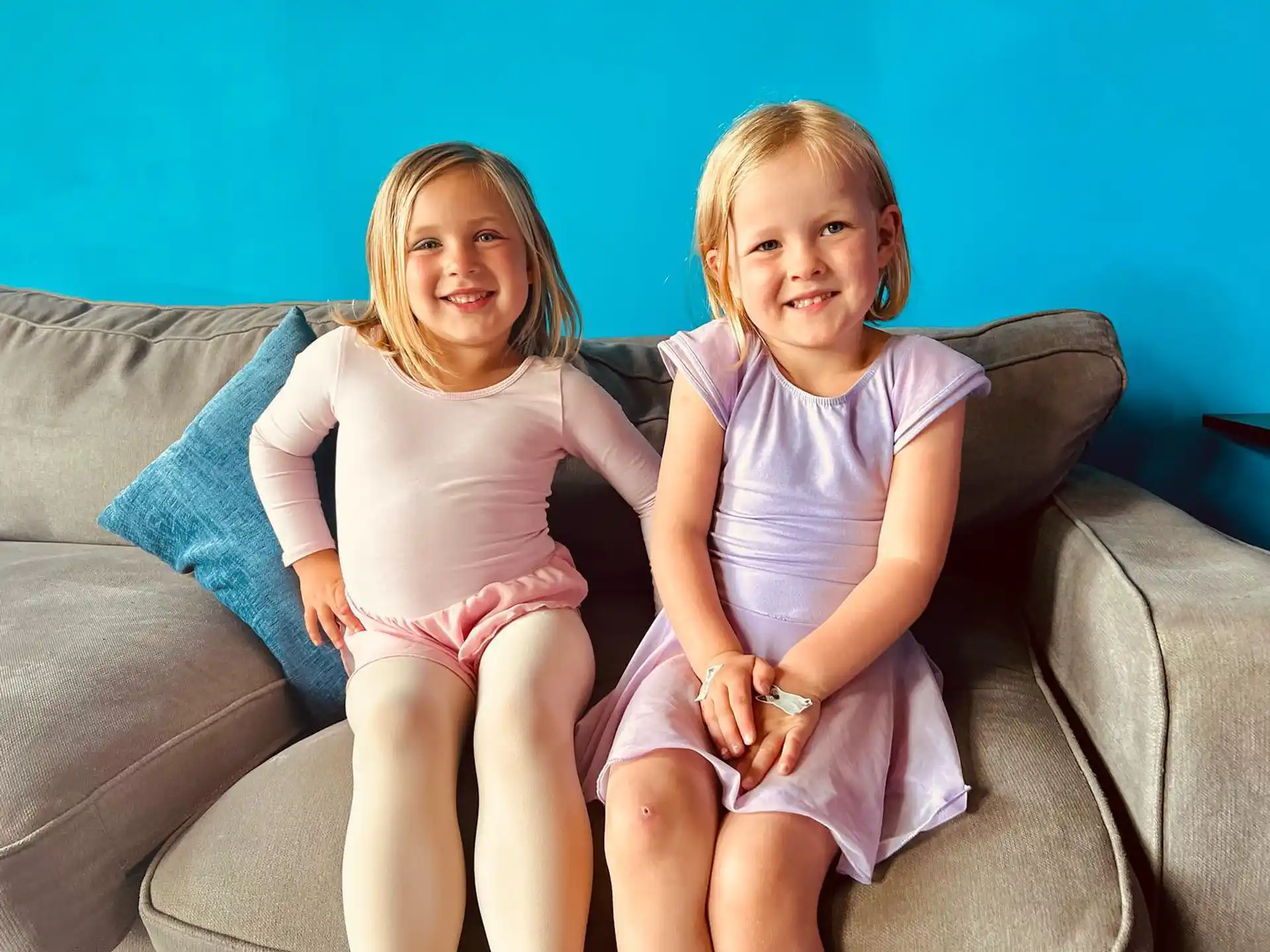 two girls sitting on a couch