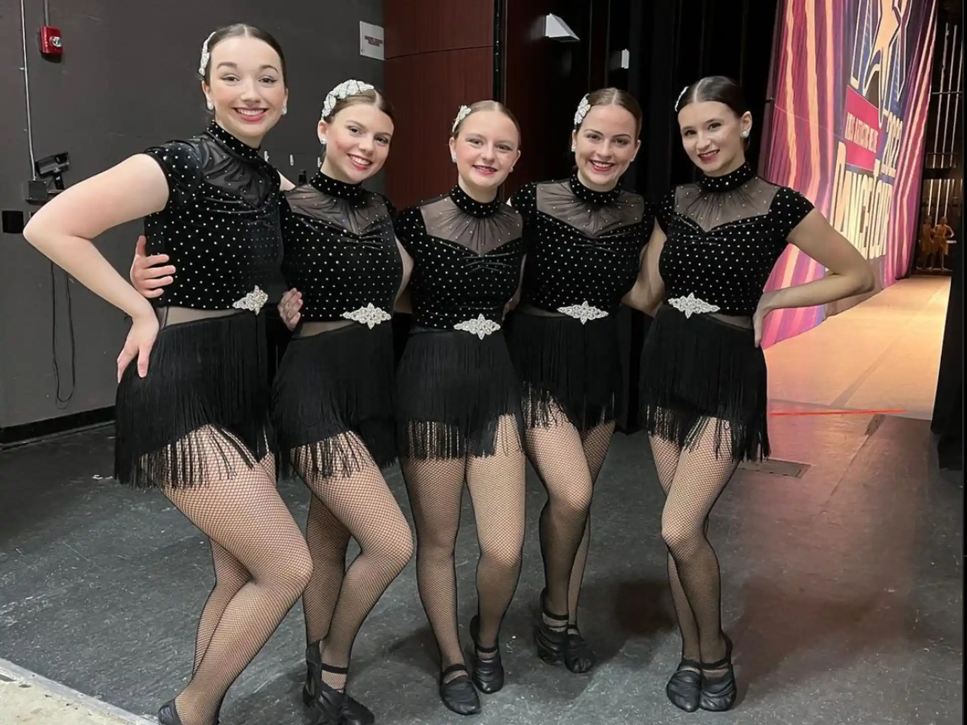 a group of women in black and white dresses