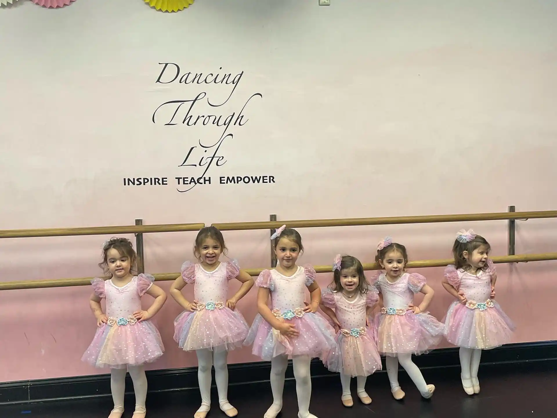 a group of girls in dresses