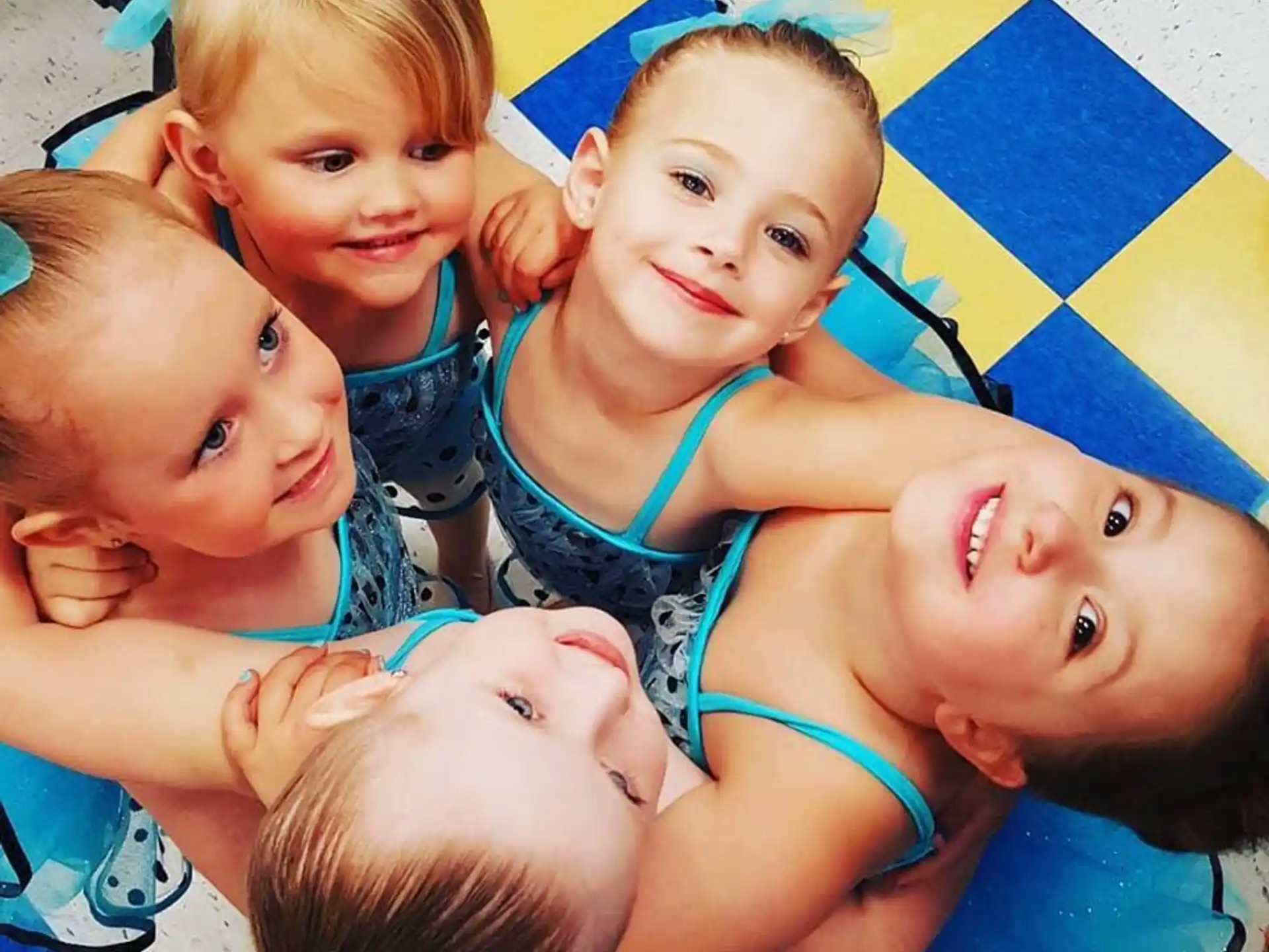 a group of children lying on a mat
