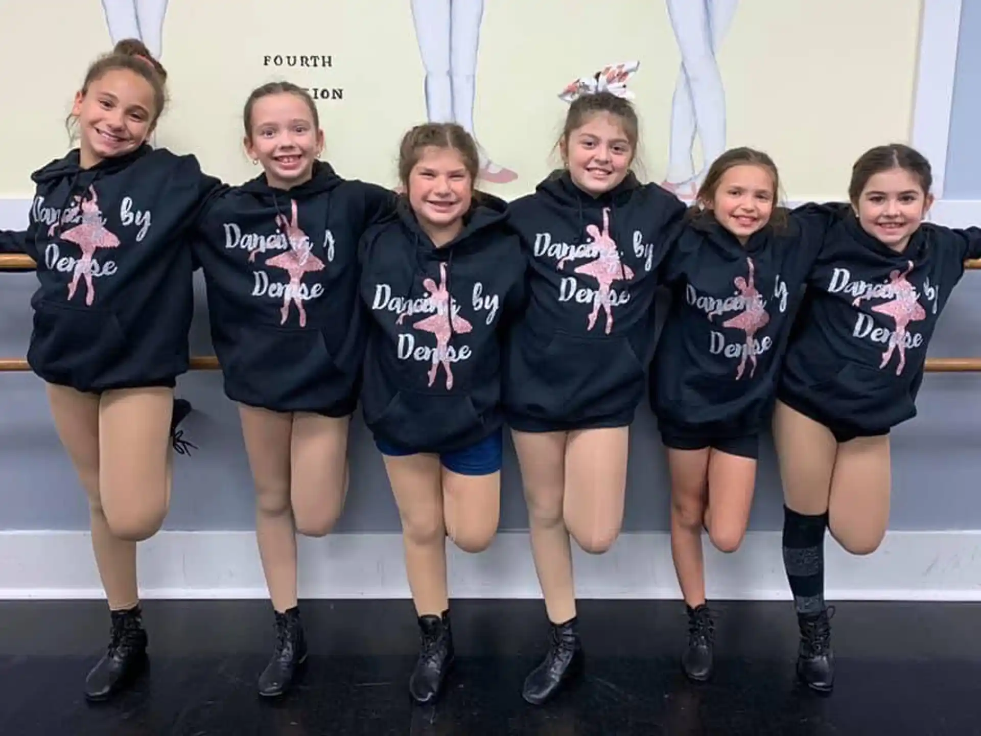 a group of girls in matching black and white uniforms