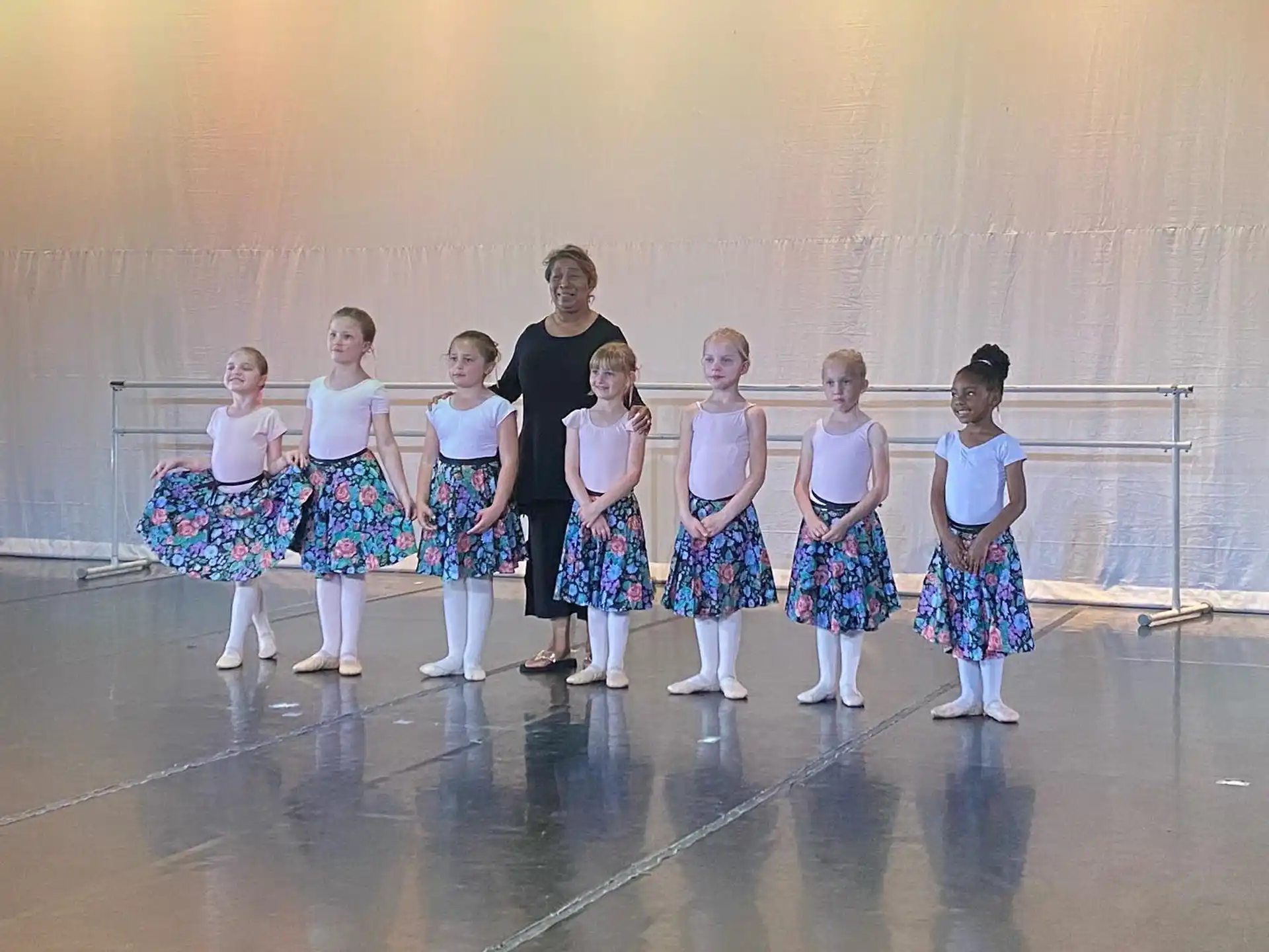 a group of children standing on a stage
