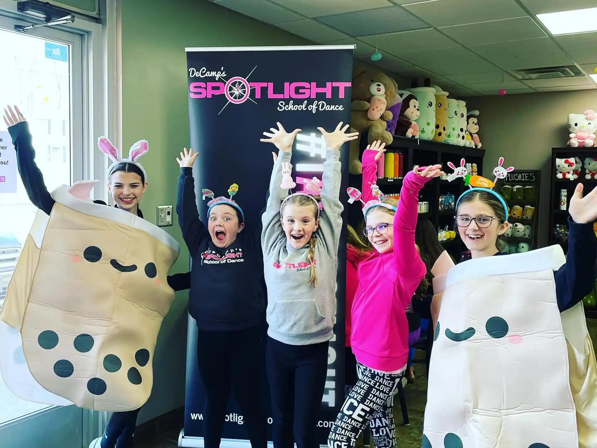 a group of girls posing for a photo with cartoon characters
